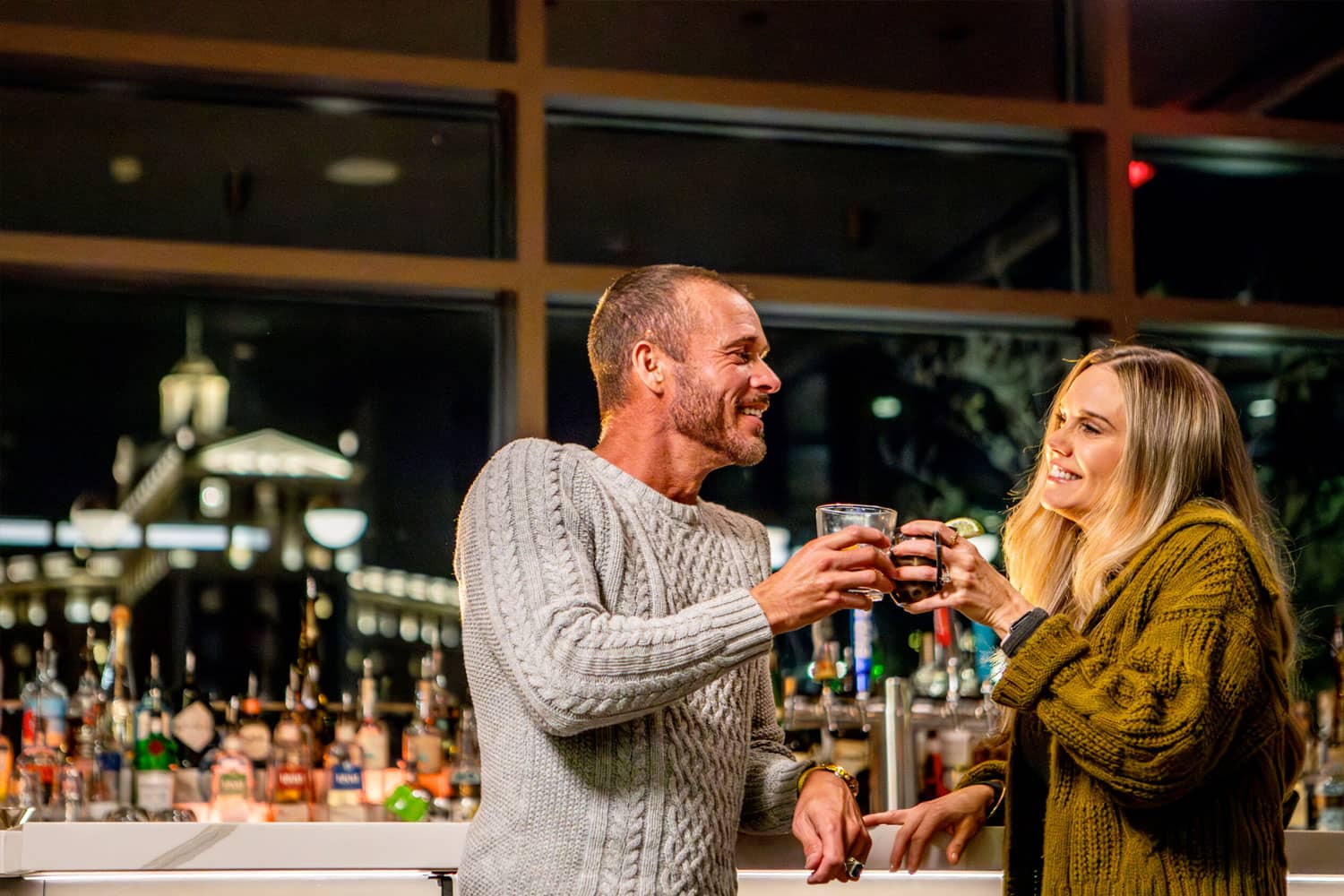 A couple sharing drinks at Arbuckle's Bar & Grill during winter