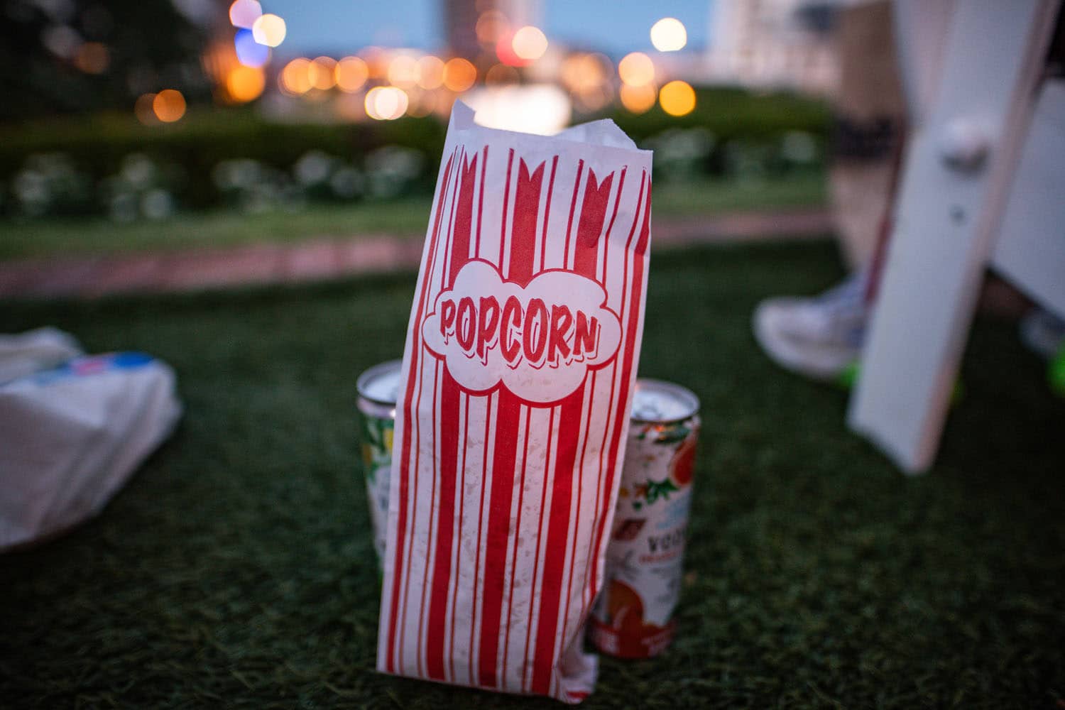 A popcorn bag and drinks on the ground during an event at The Historic Cavalier Hotel