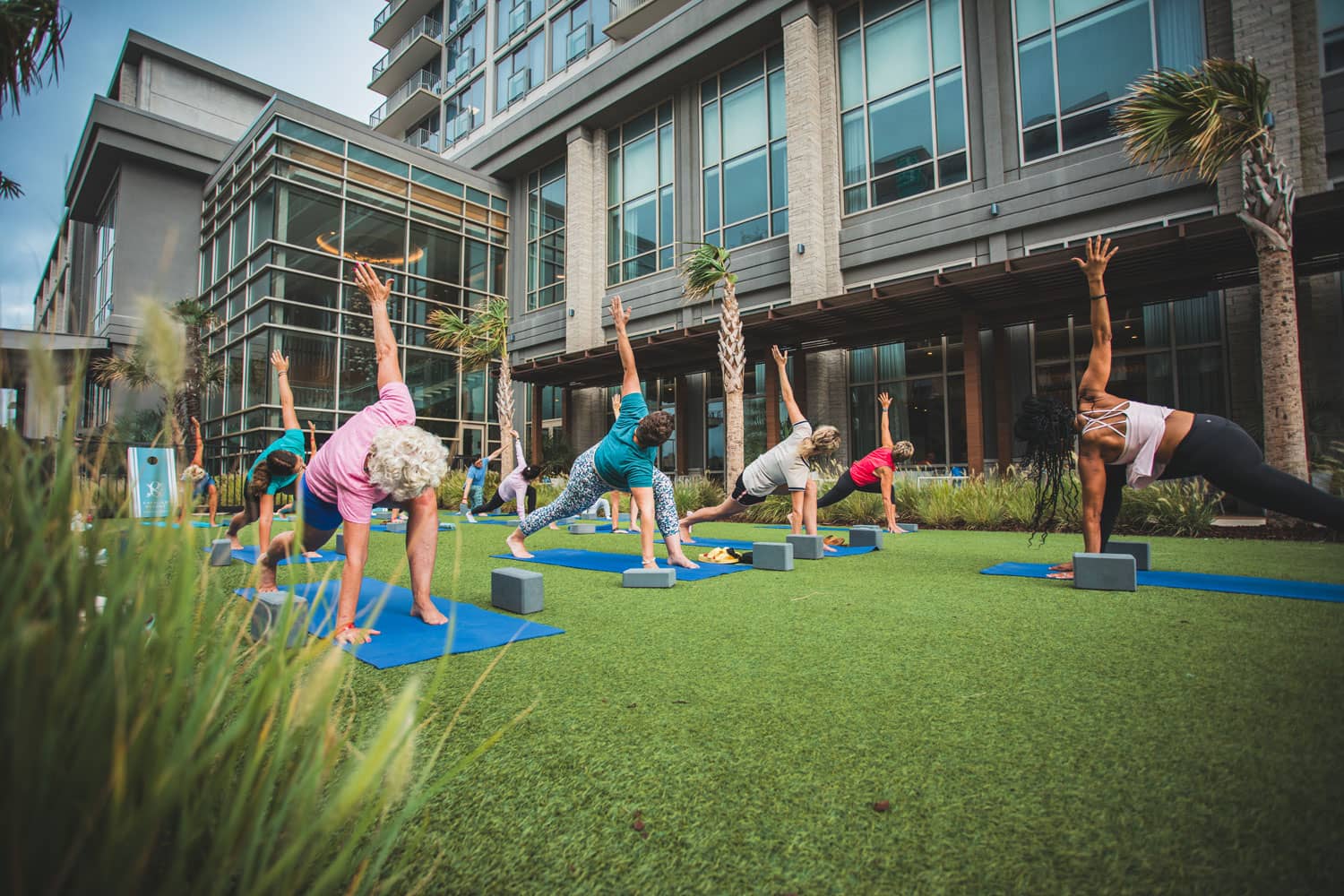 A group yoga class next to the ocean at the Cavalier Resort