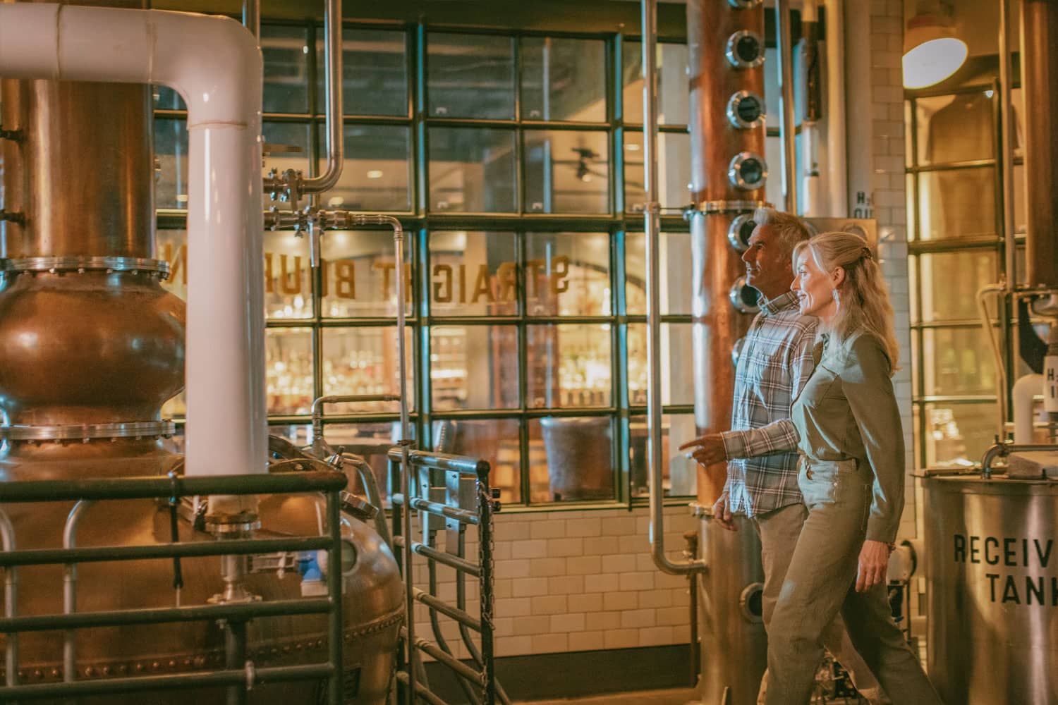 A couple enjoying a tasting and tour of Tarnished Truth Distilling Company