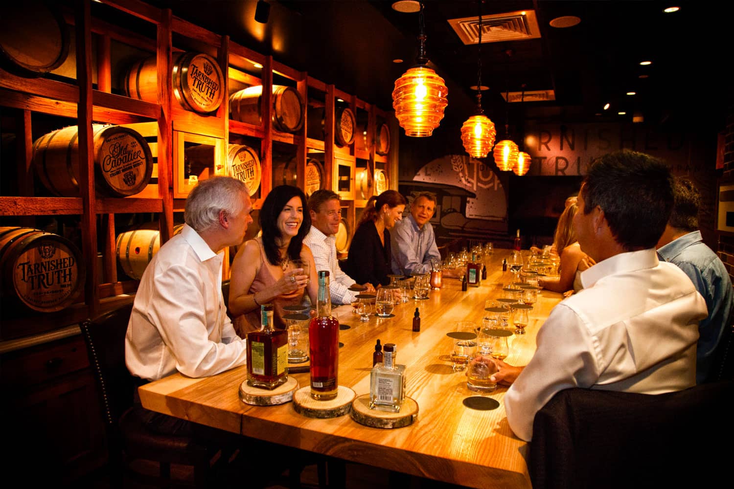 People enjoying a spirits tasting in the private tasting room at Tarnished Truth Distilling Company