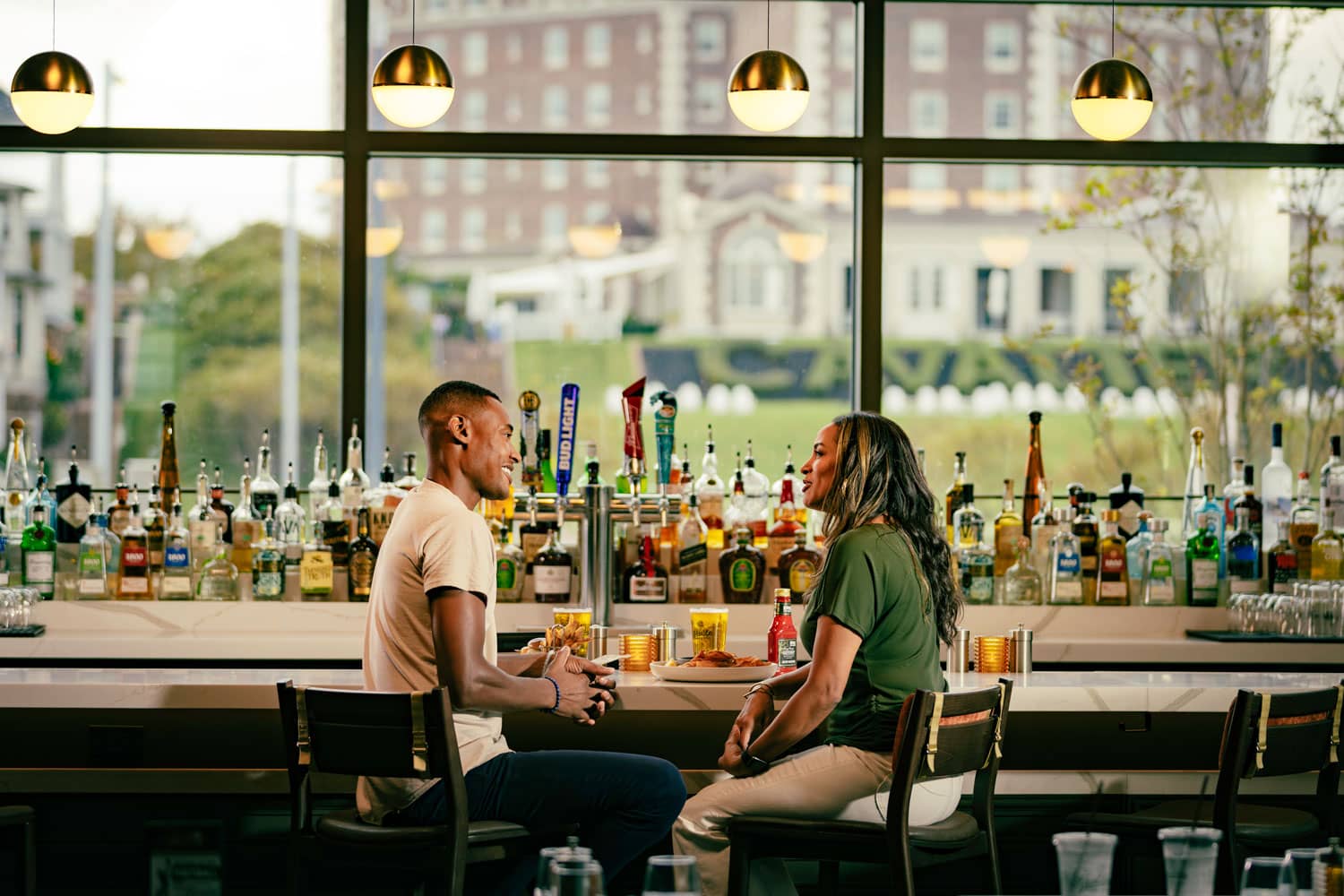 Two people sitting at the bar inside Arbuckle's Bar & Grill