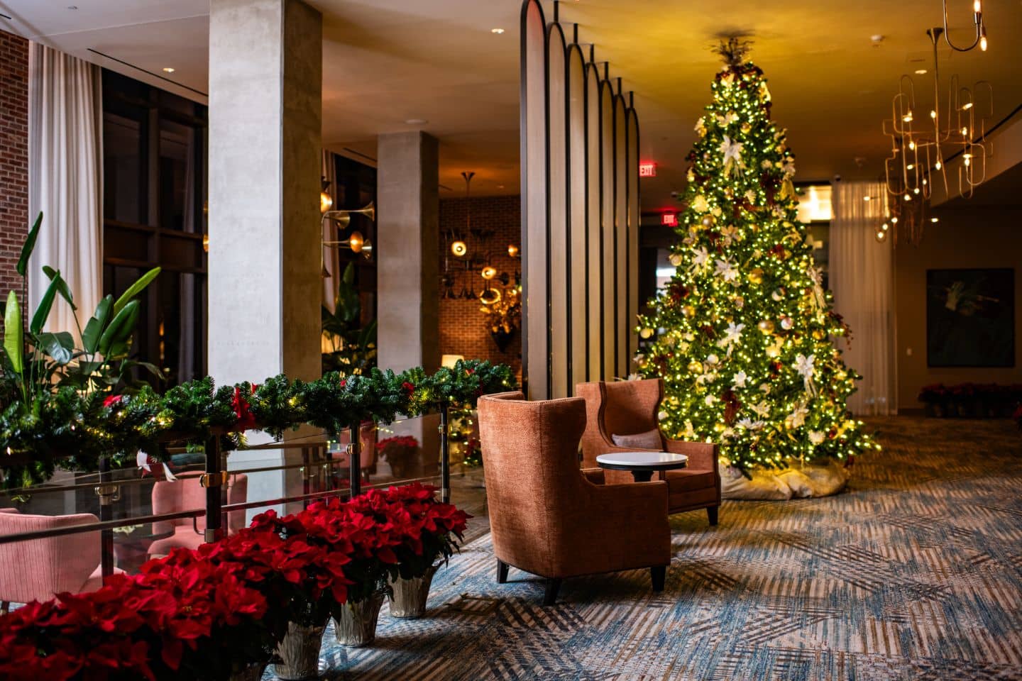 An elegant hotel lobby decorated with festive holiday decor