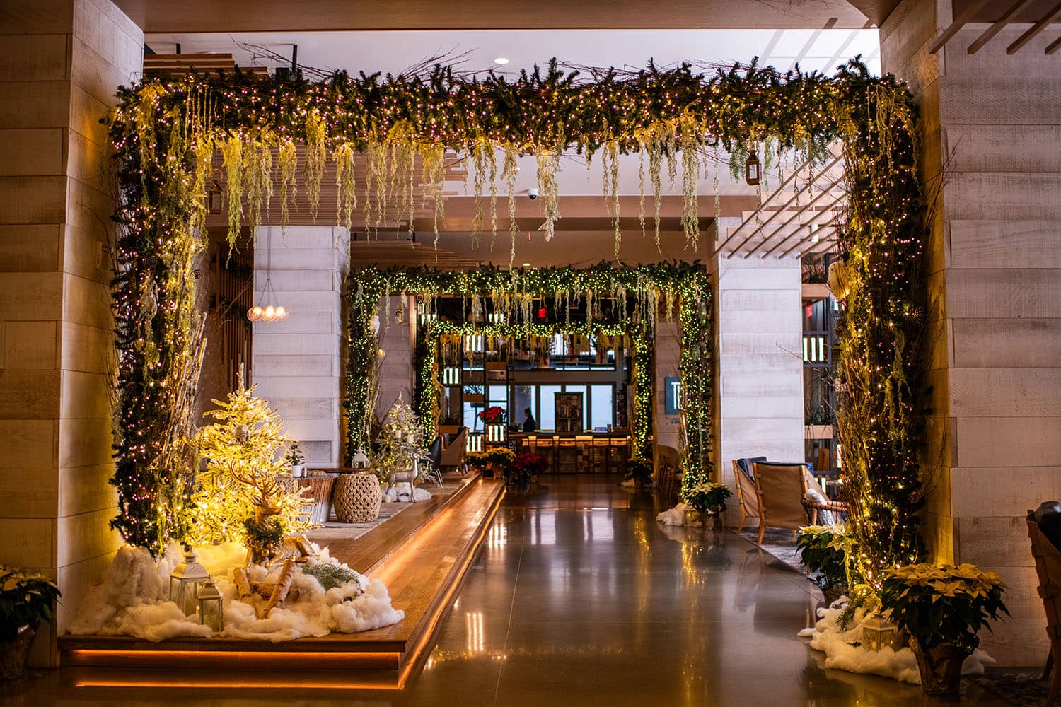 An elegantly decorated hotel lobby with white lights and garland