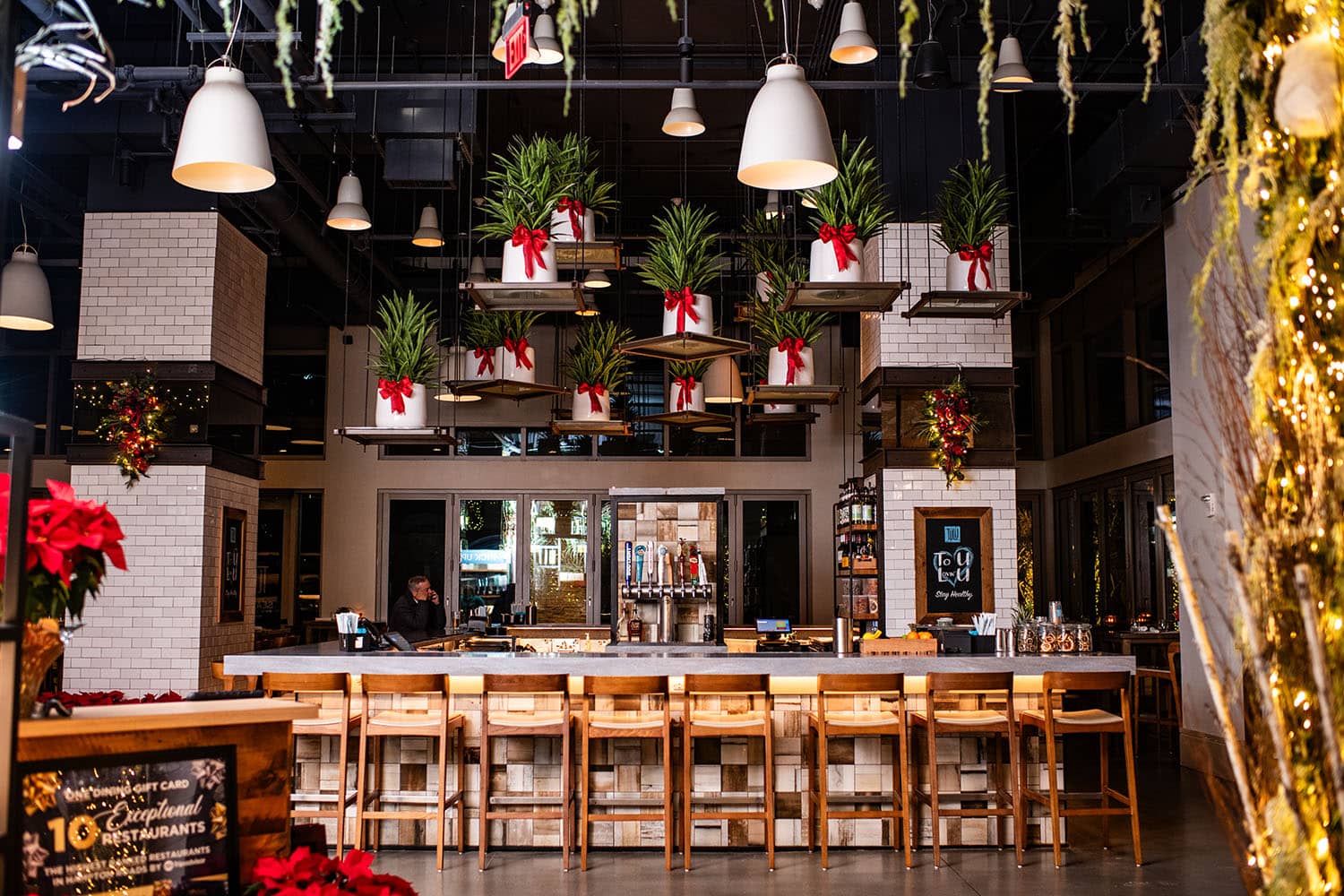 An elegantly decorated restaurant with white lights and garland