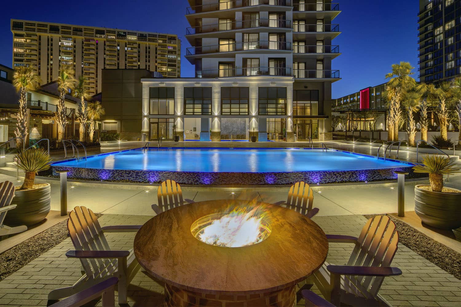 An outdoor firepit next to an outdoor pool