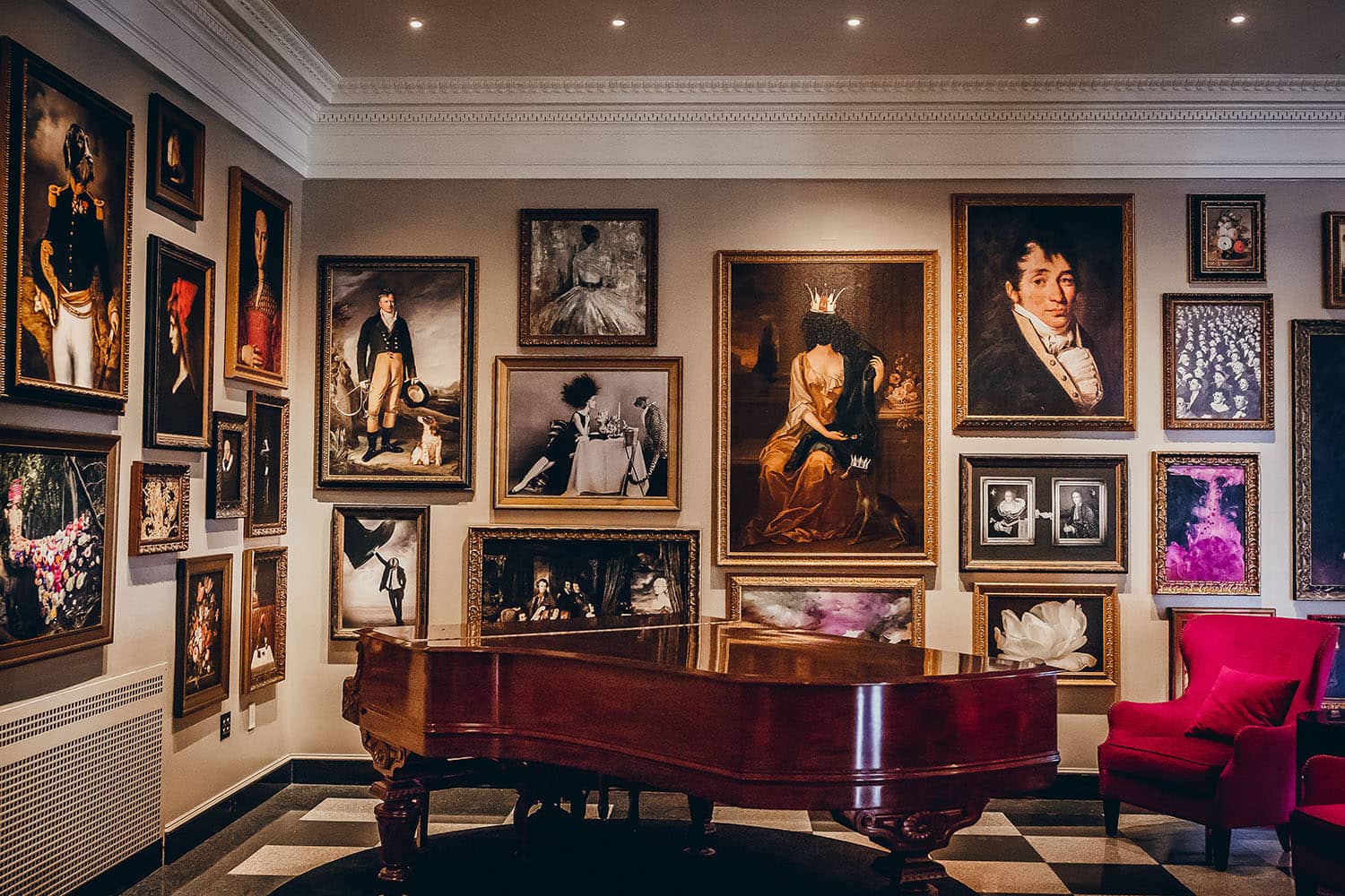 Paintings on a wall with a piano displayed in front