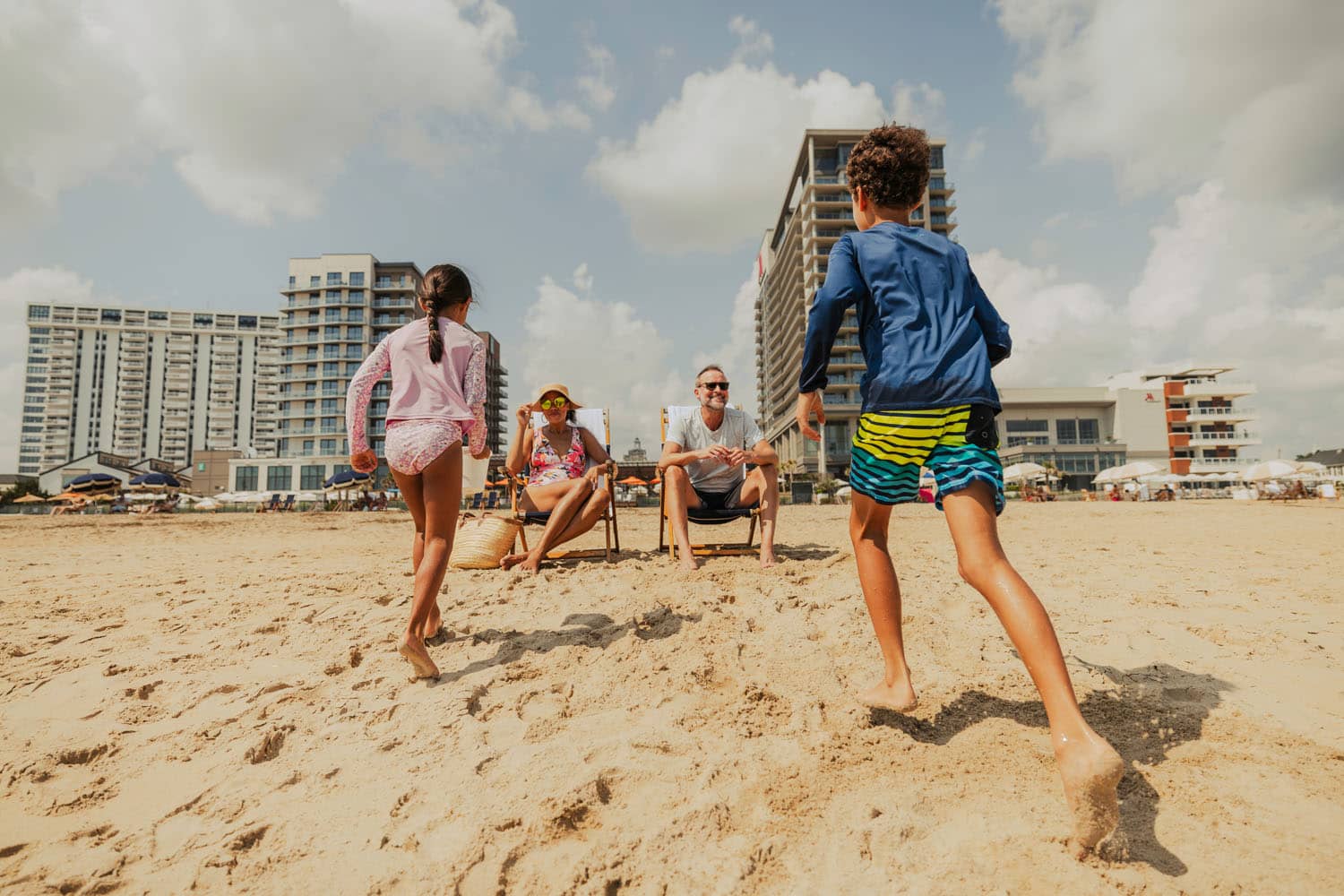 Two children running on the beach