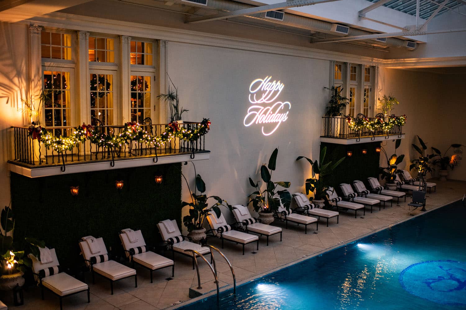 An empty indoor pool with holiday decorations