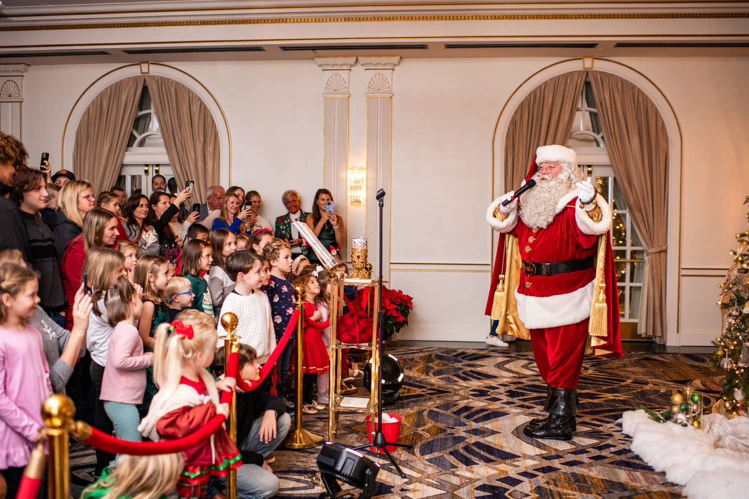 Santa signing songs for children at an event