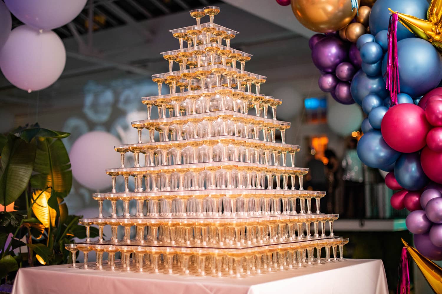 Dozens of champagne glasses stacked on top of each other on a table