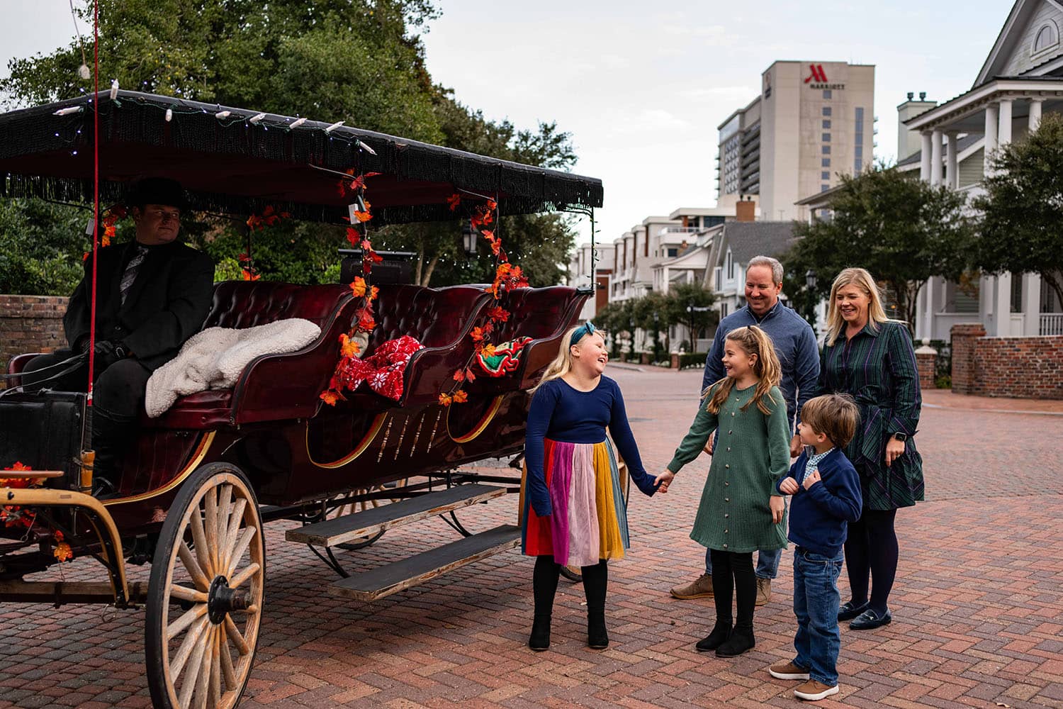 A family about to board a horse-drawn carriage ride