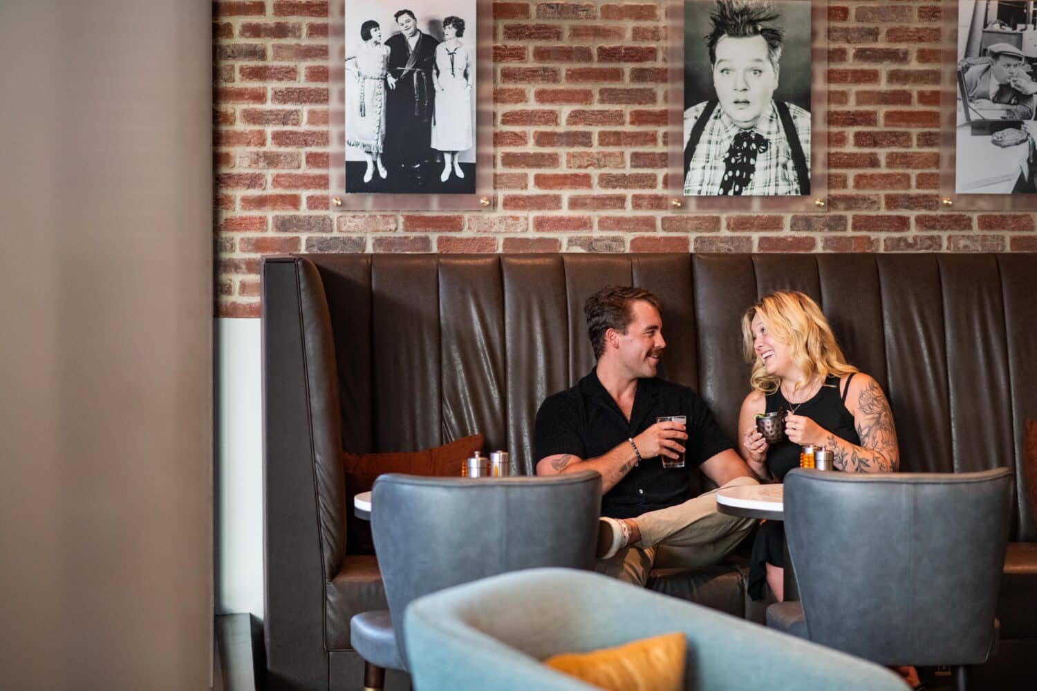 A couple sitting inside the dining room at Arbuckle's Bar & Grill.