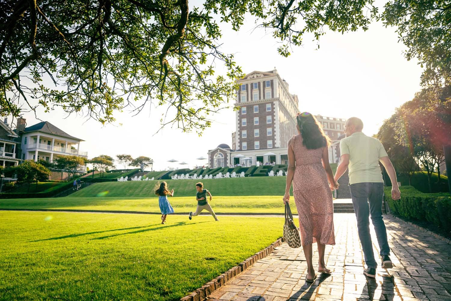 A family walking on the lawn at The Historic Cavalier Hotel