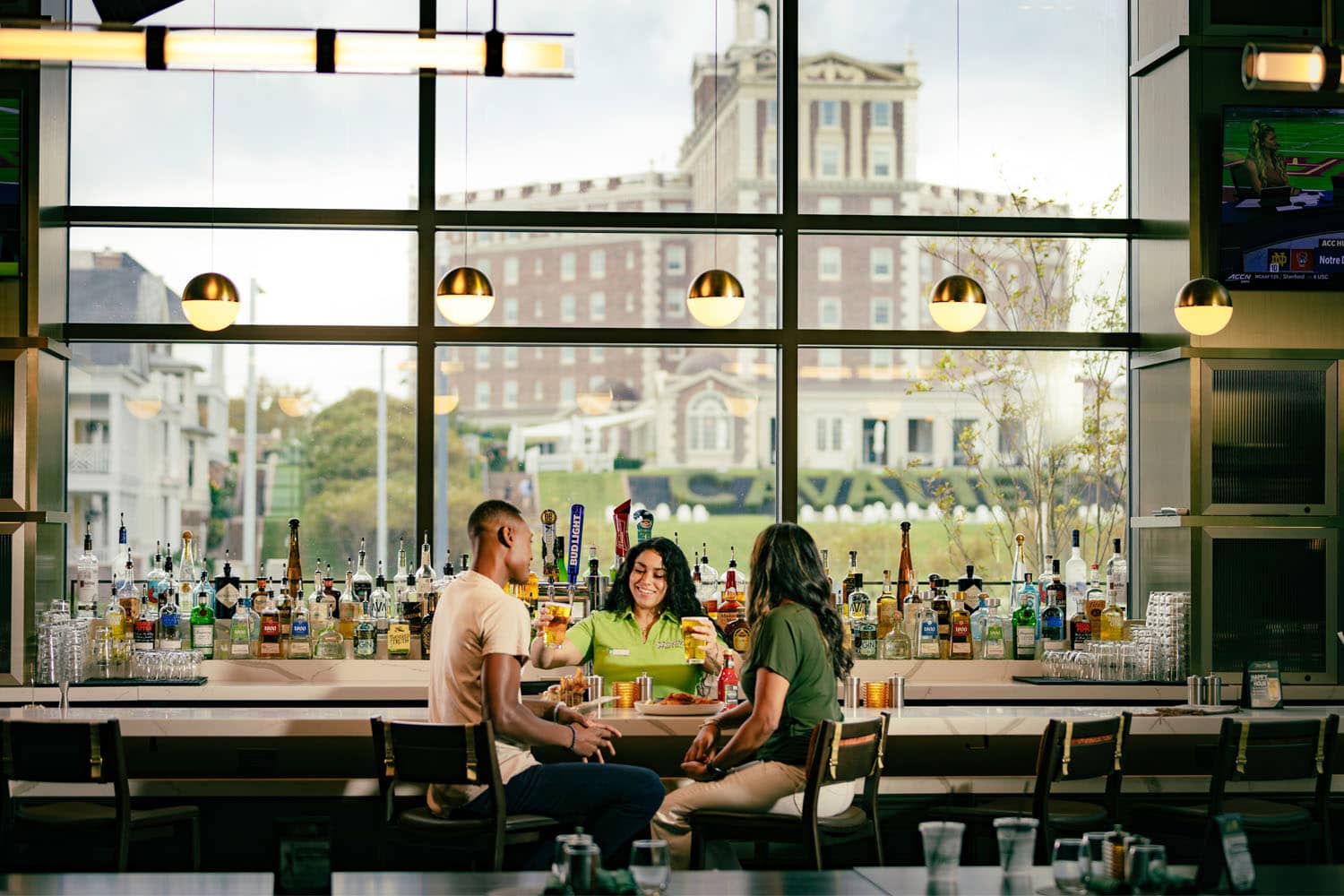 A couple dining at the bar inside Arbuckle's Bar & Grill at the Cavalier Resort