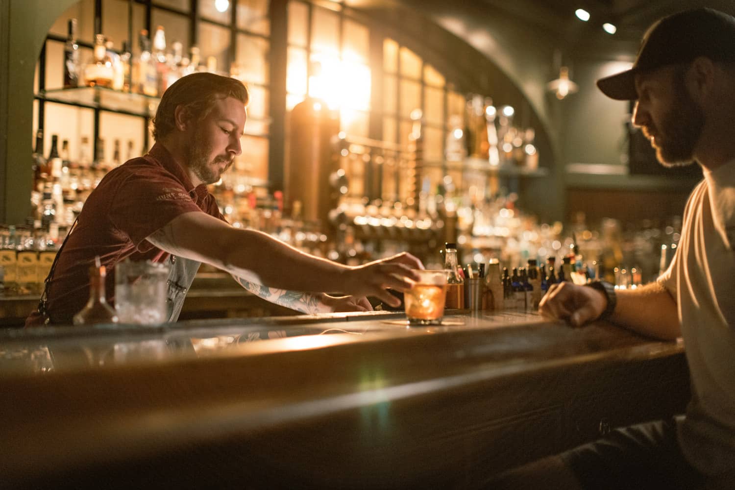 A bartender serving a drink at the Hunt Room