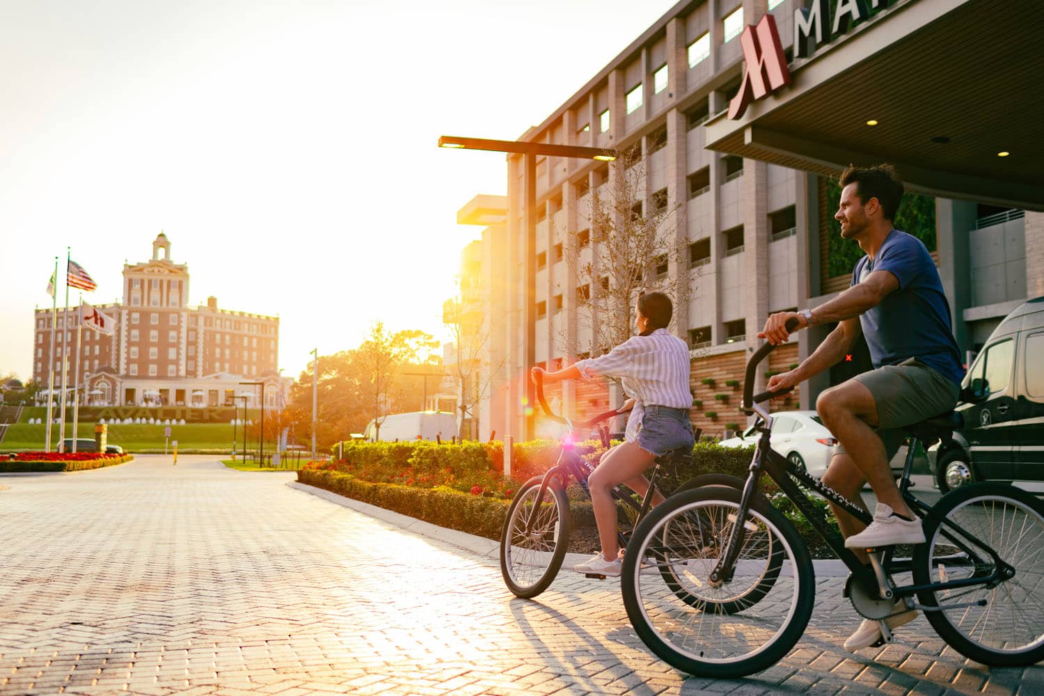 A couple riding bikes together at sunrise