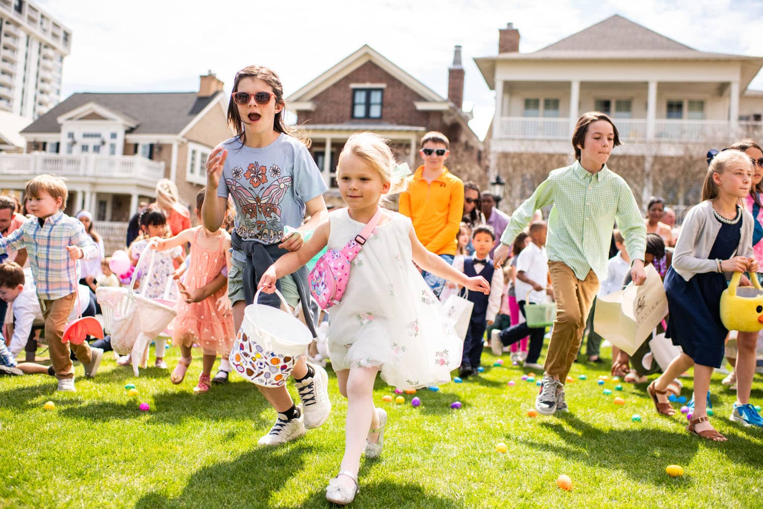 A group of children running on grass during an Easter egg hunt