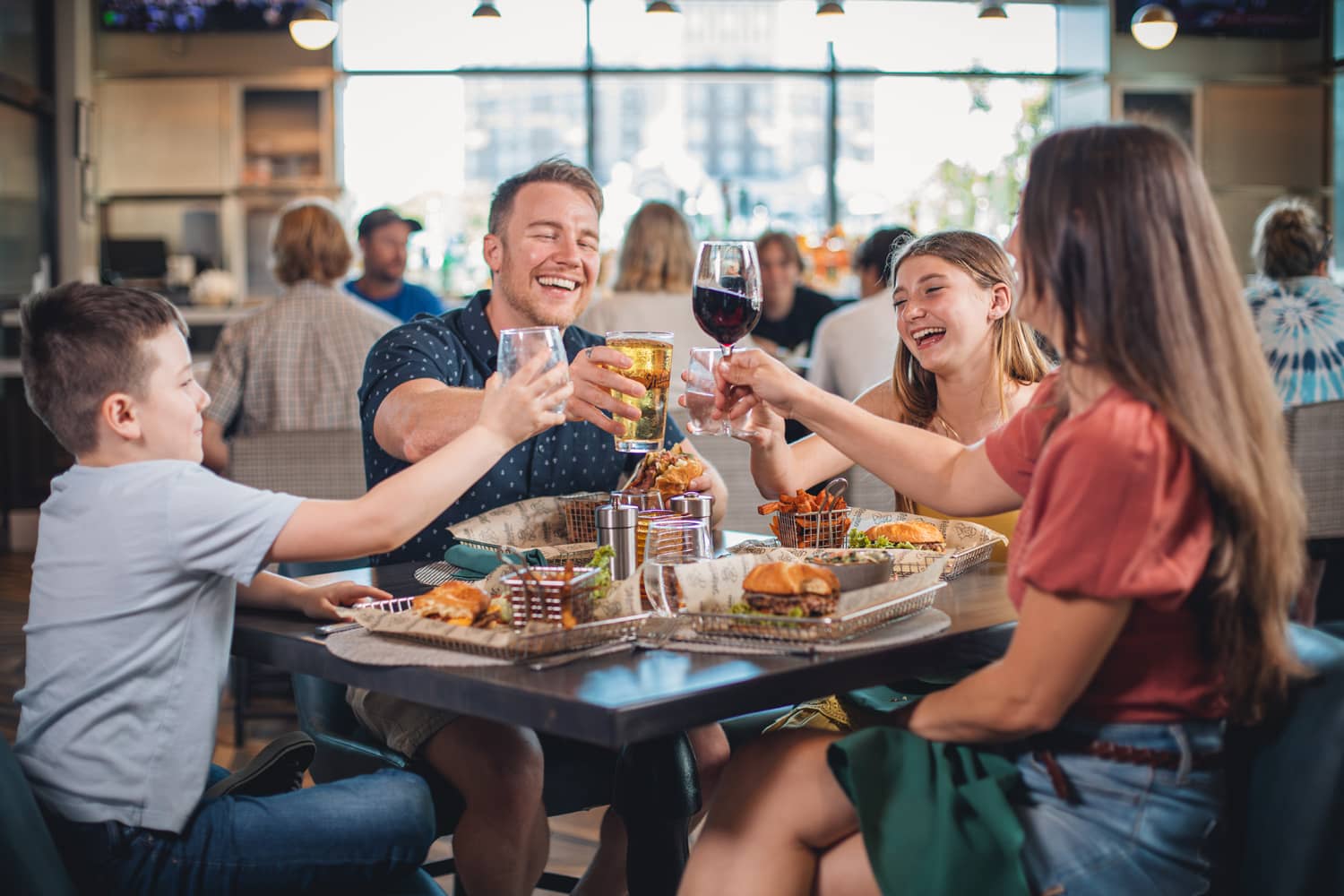 A family of four eating a meal inside Arbuckle's Bar & Grill