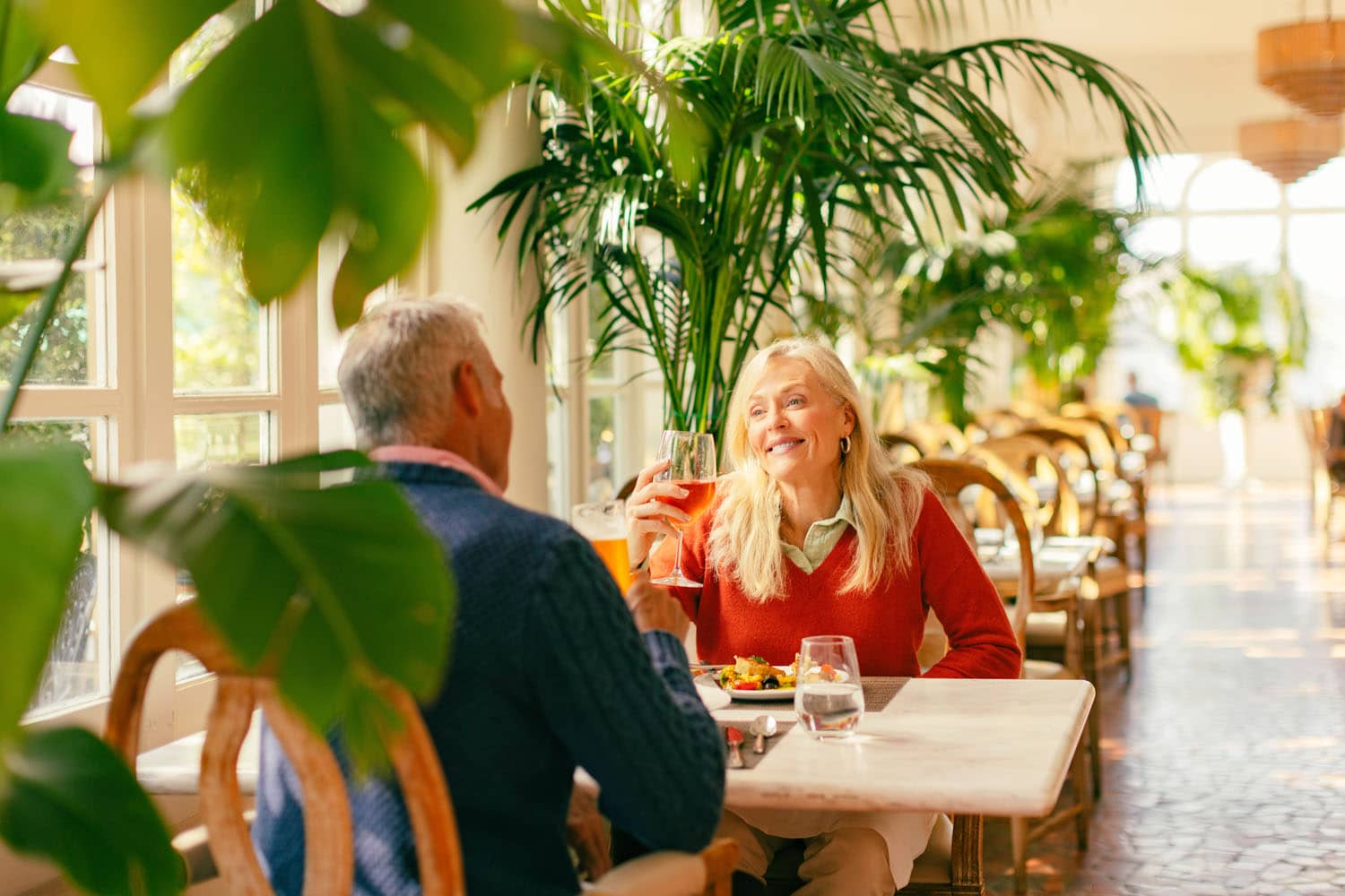 A couple dining in a loggia at Becca Restaurant & Garden