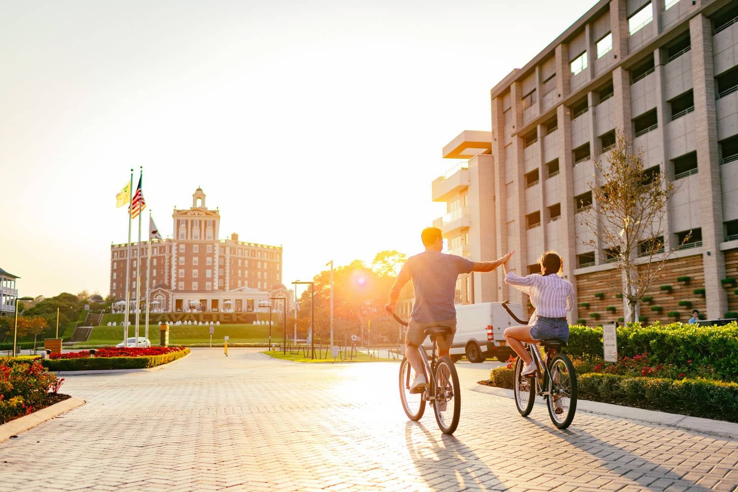 A couple riding bikes in front of the Marriott Virginia Beach Oceanfront Resort