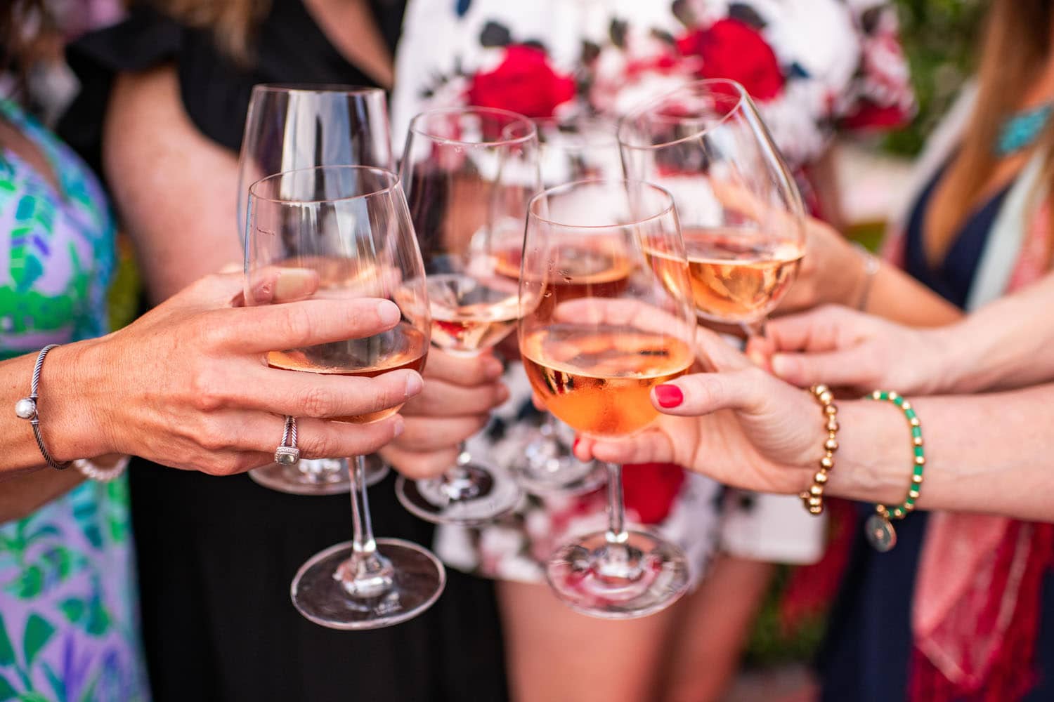 A group of wine glasses filled with pink rose