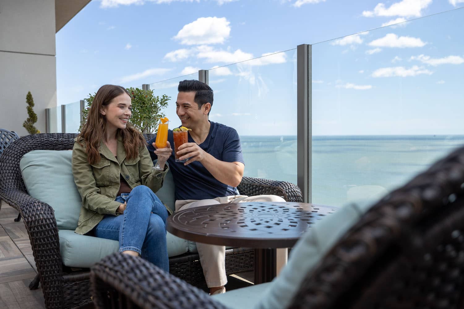 A couple enjoying drinks on a rooftop patio at Orion's Roof