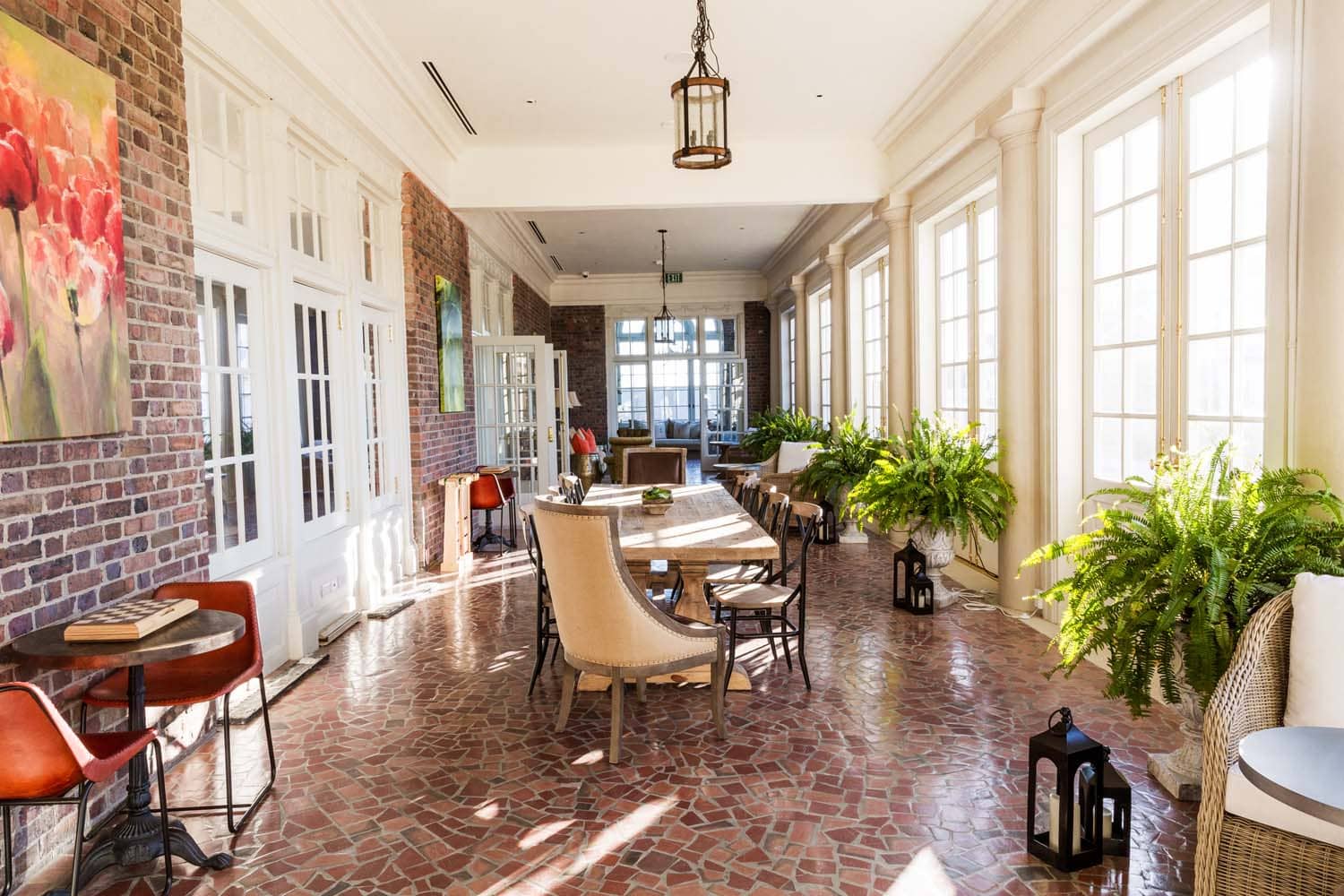 The interior lounge area of The Raleigh Room loggia inside The Historic Cavalier Hotel