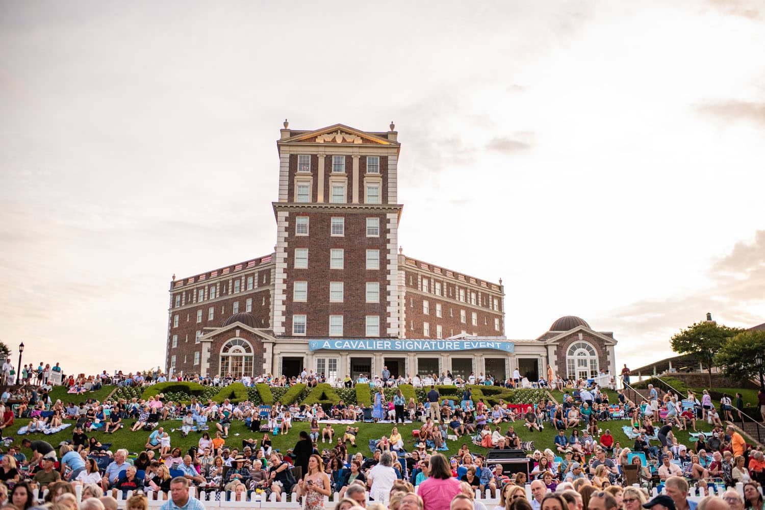 An outdoor event on the lawn at The Historic Cavalier Hotel during the summer
