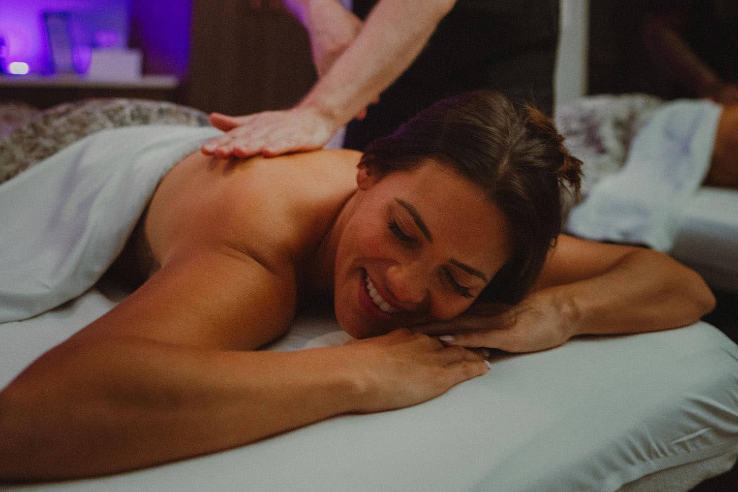 A woman receiving a massage on a table