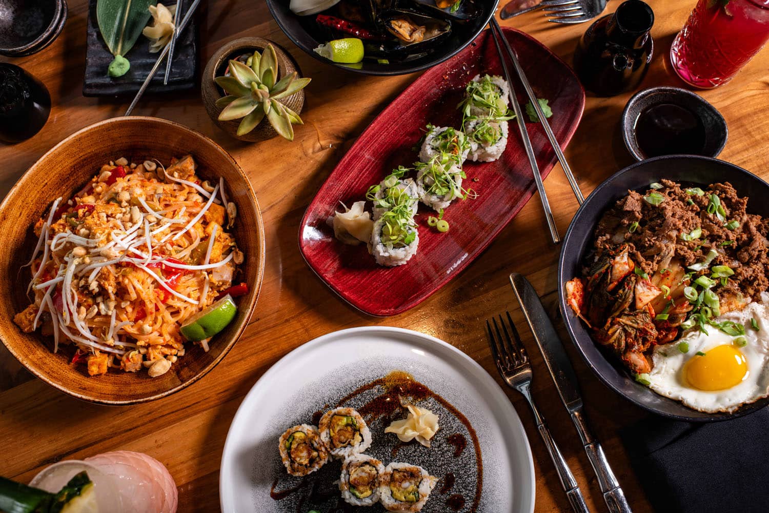 A closeup view of plated dishes on a decorated table at Orion's Roof