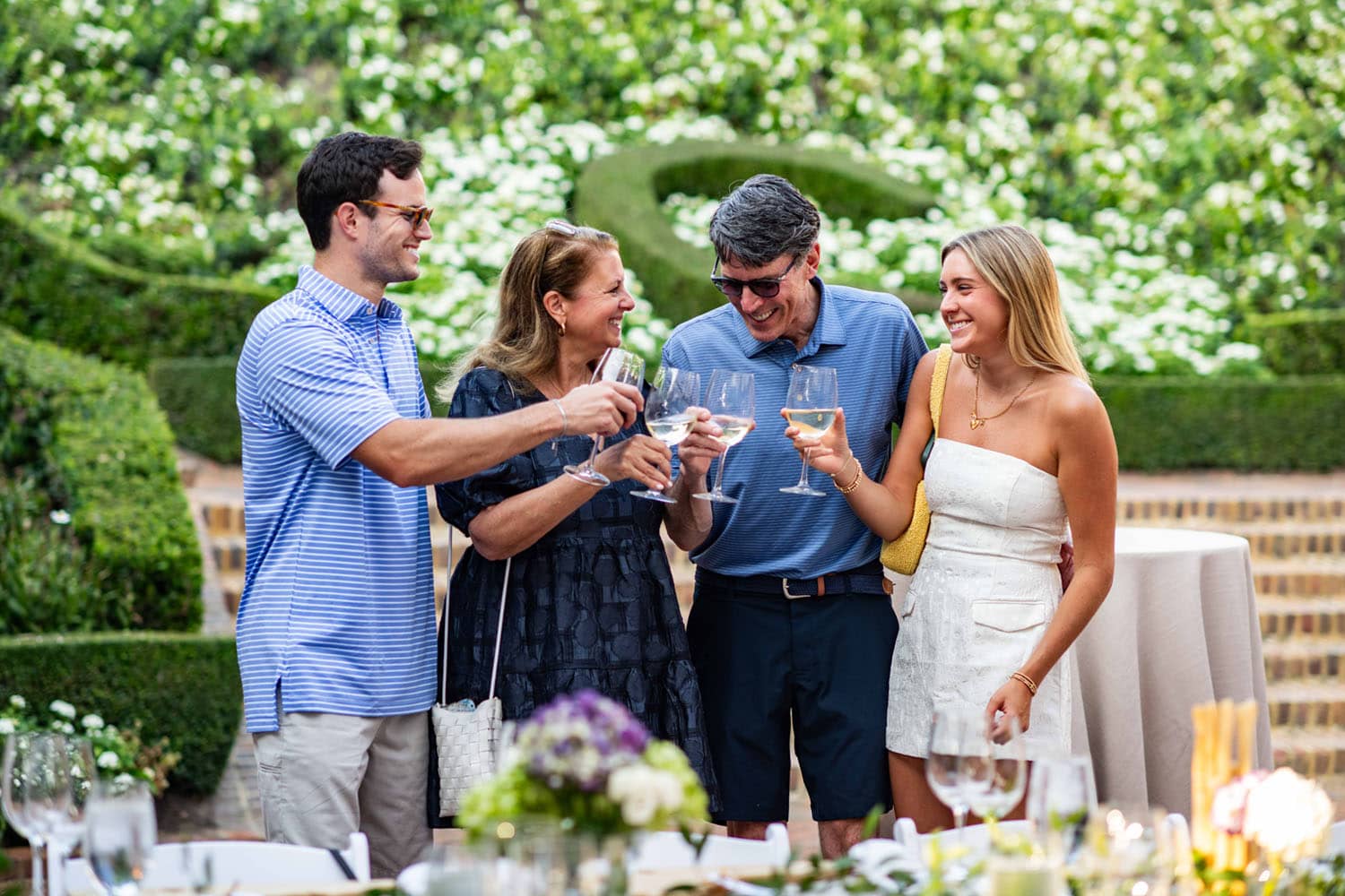 A family drinking wine in an outdoor garden