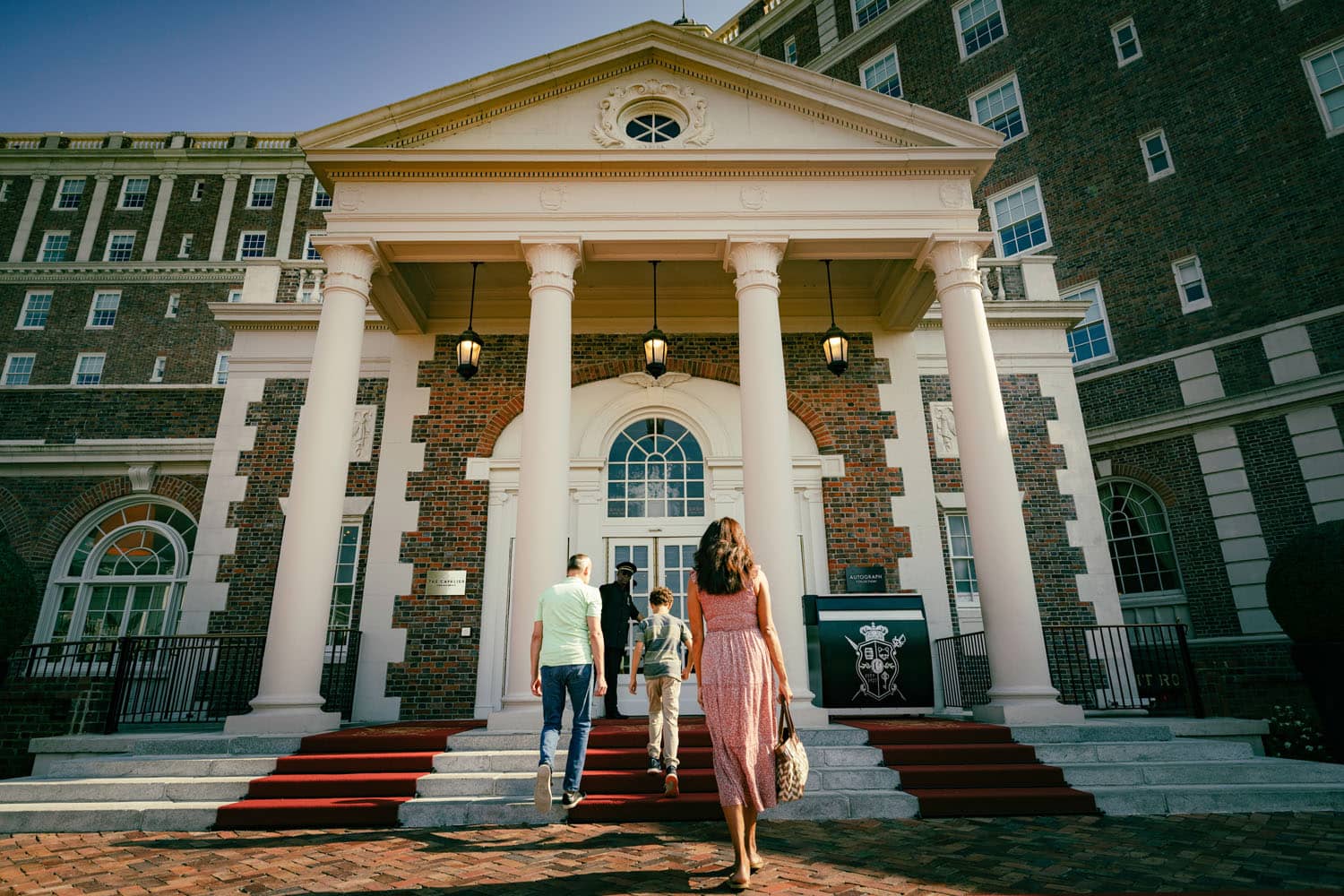 A family walking into The Historic Cavalier Hotel