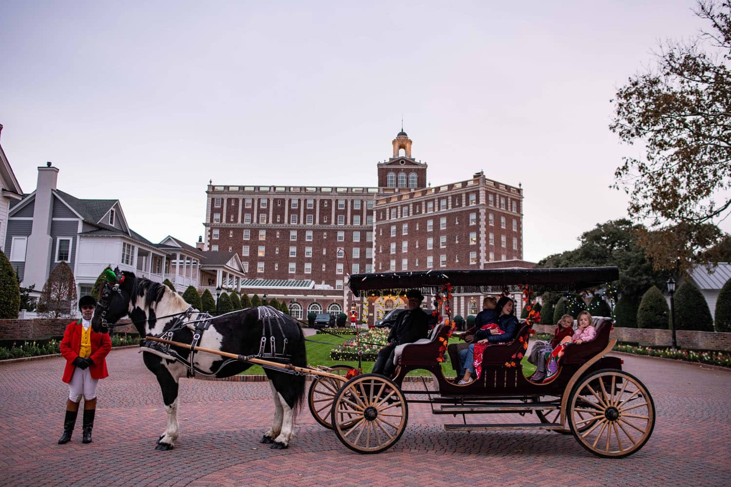 A horse-drawn carriage in front of The Historic Cavalier Hotel