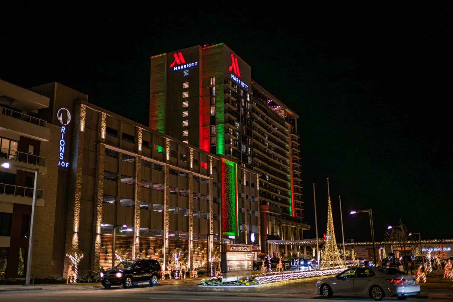 An exterior hotel at night with holiday lights decoration