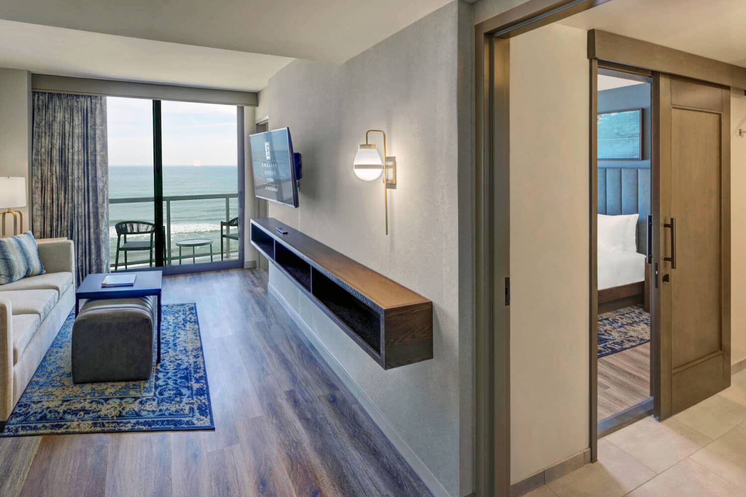 A bedroom suite inside the Embassy Suites Virginia Beach Oceanfront Resort