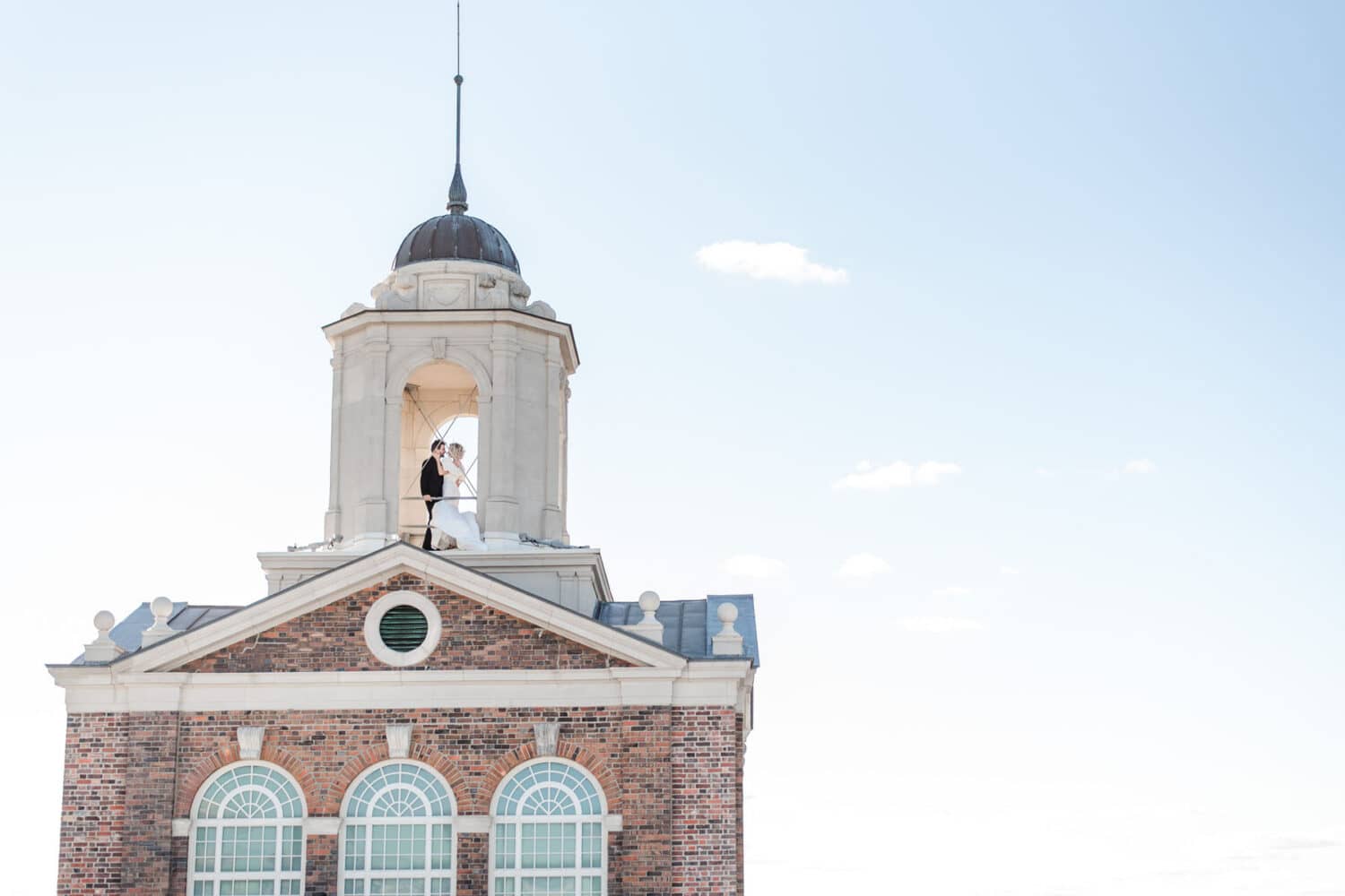A newlywed couple sharing a moment atop The Historic Cavalier Hotel Bell Tower