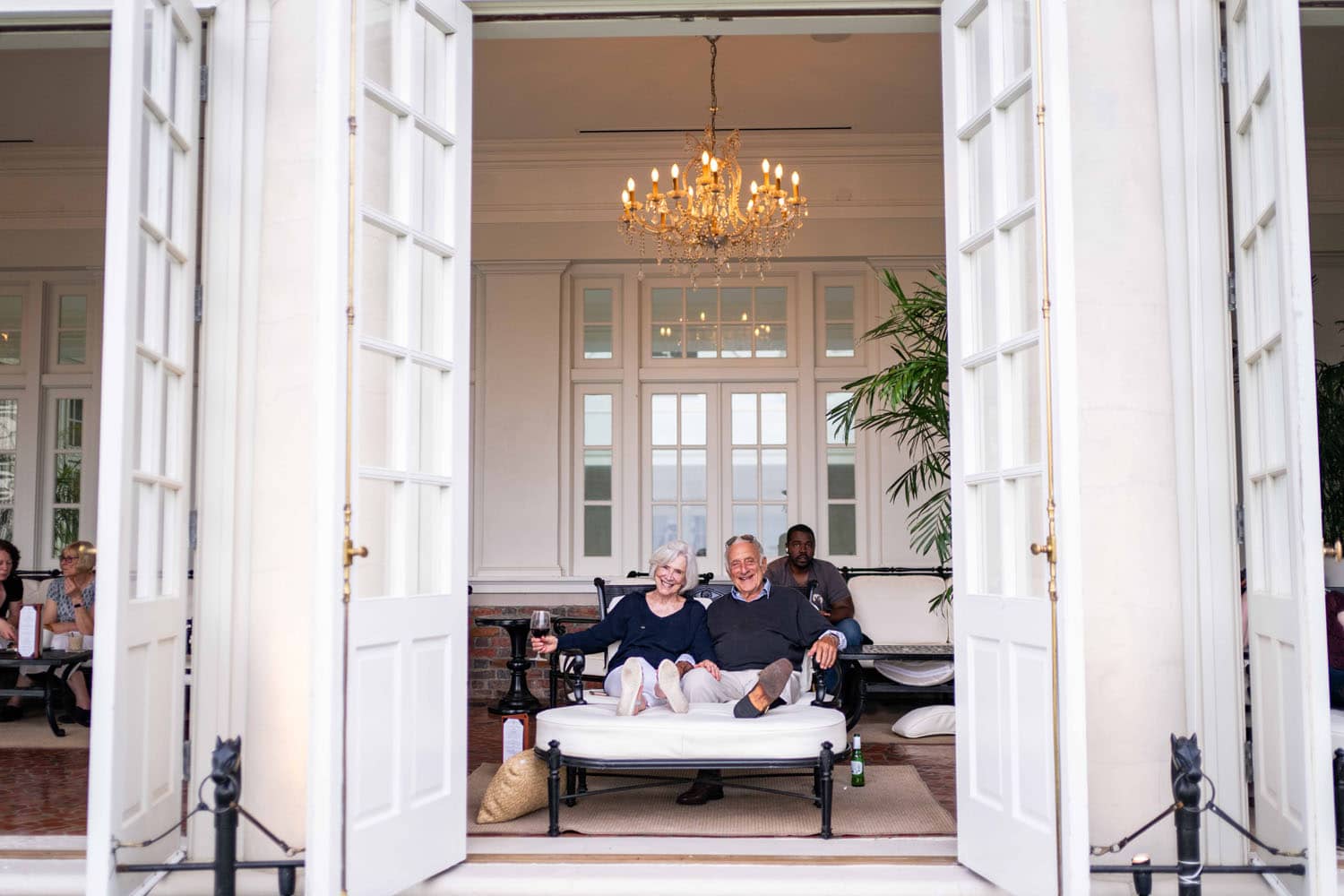 An elderly couple sharing wine inside a lounge at The Cavalier Hotel