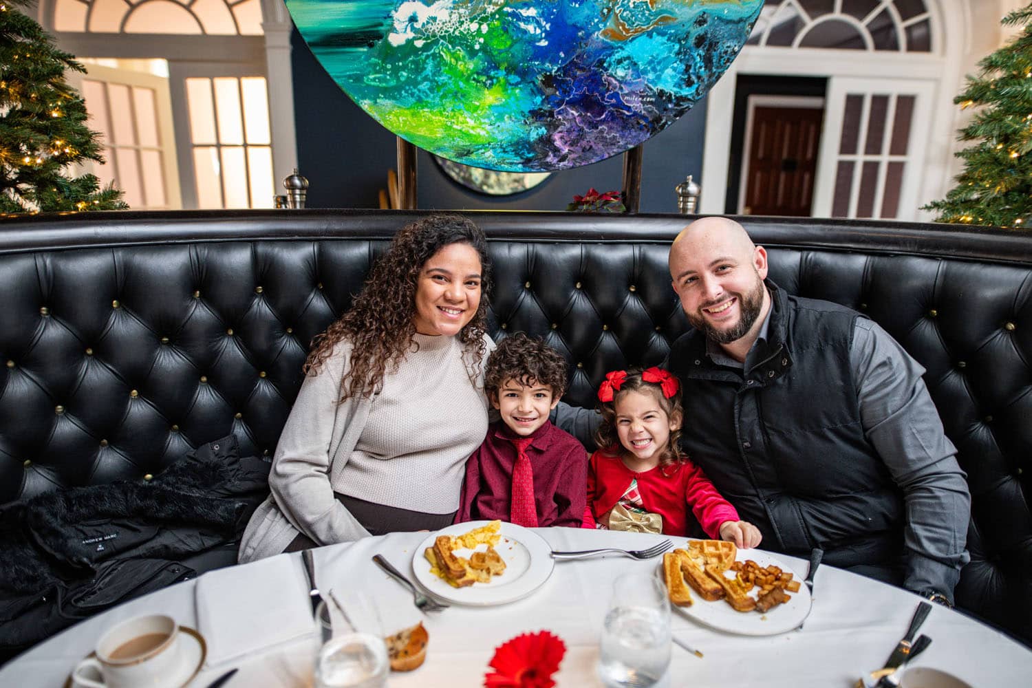 A family enjoying dinner at a table during the Holidays