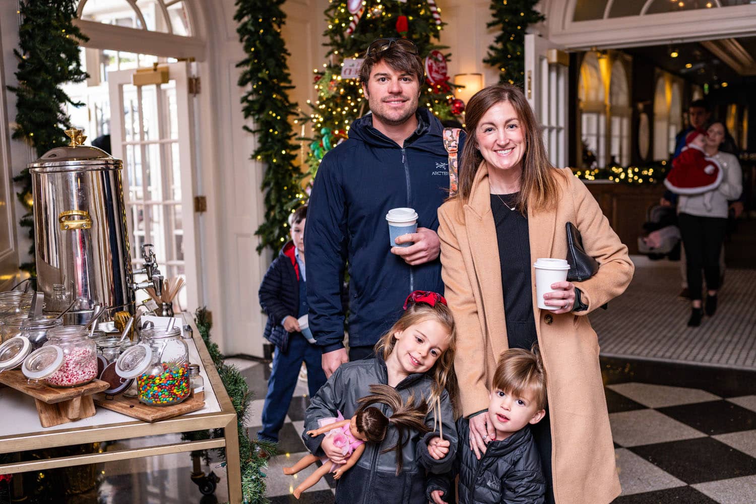 A family enjoying photos with Santa at The Historic Cavalier Hotel