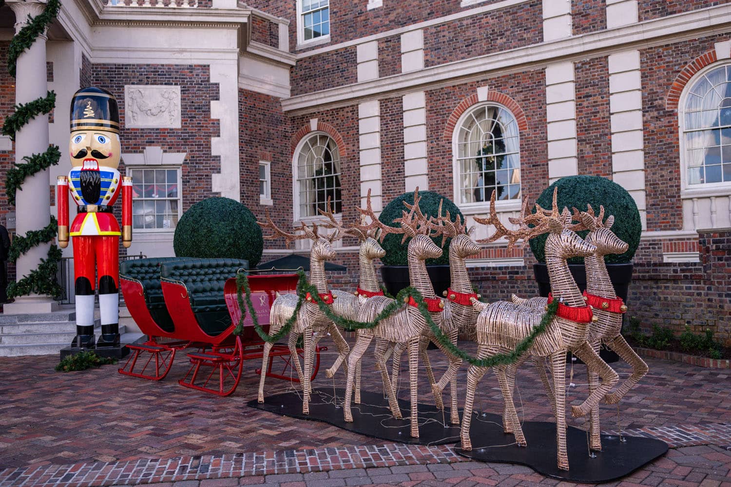 A Santa sleigh and decorative reindeer outside The Historic Cavalier Hotel