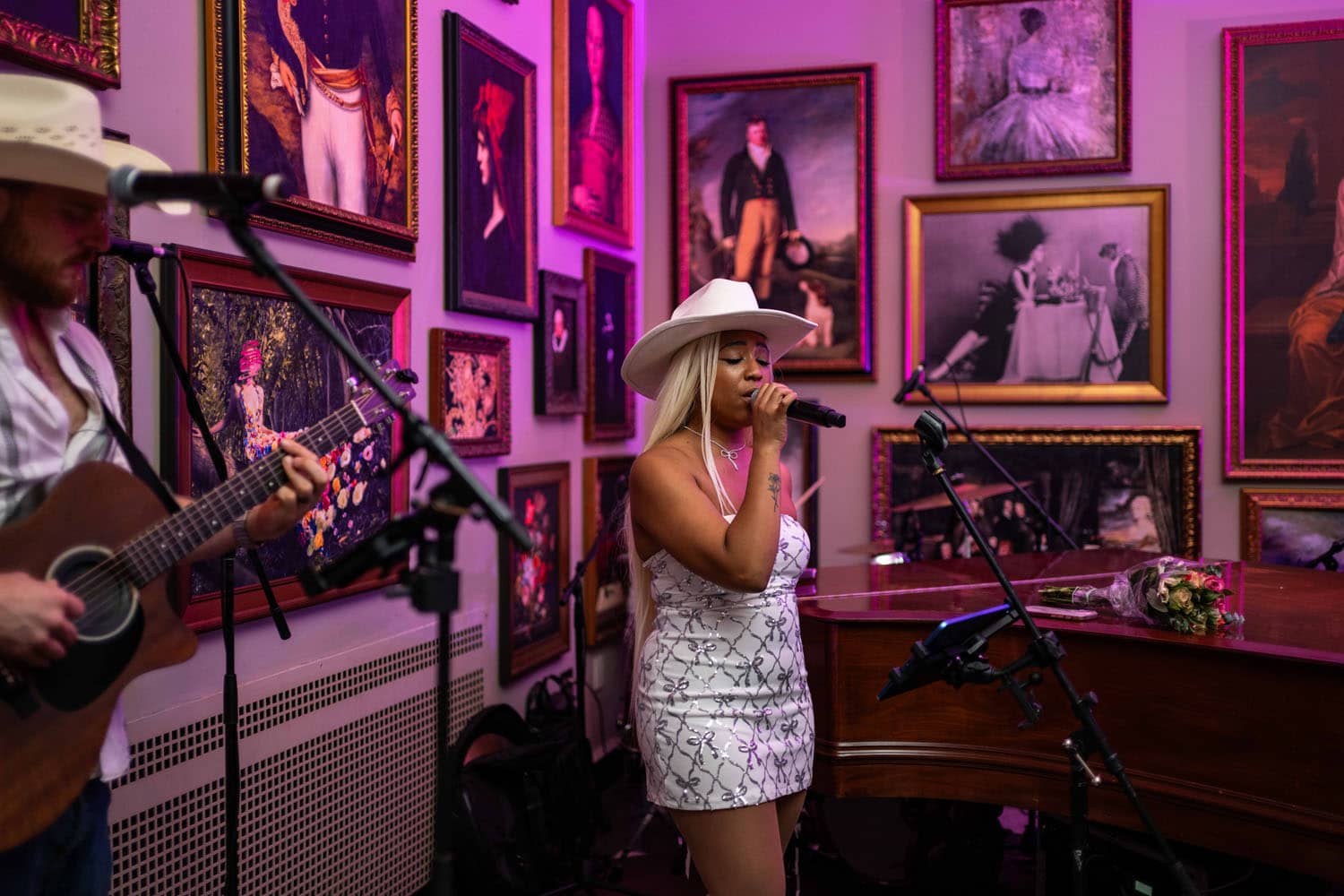 An artist performing live music inside The Raleigh Room