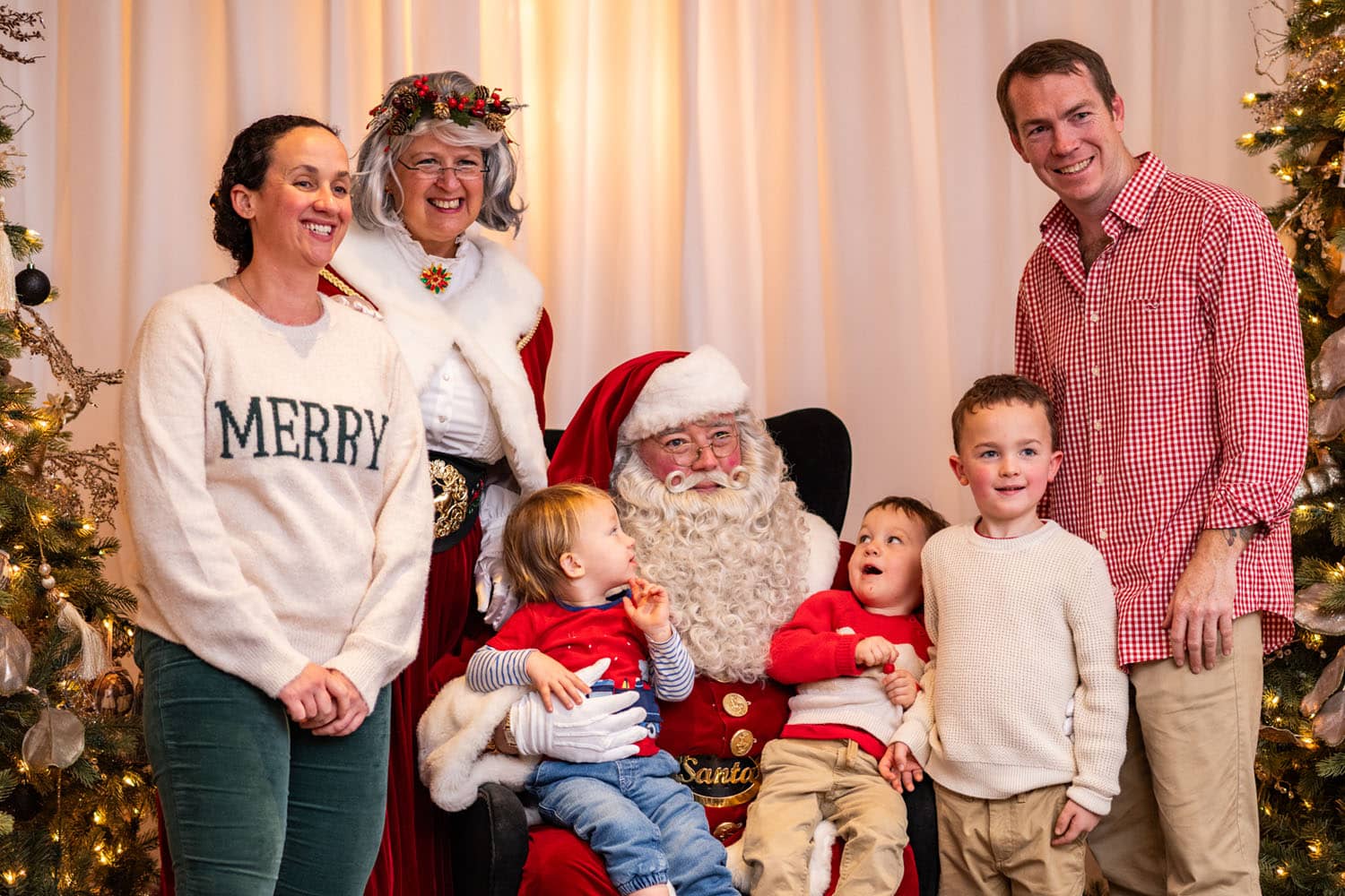A family posing for a photo with Santa