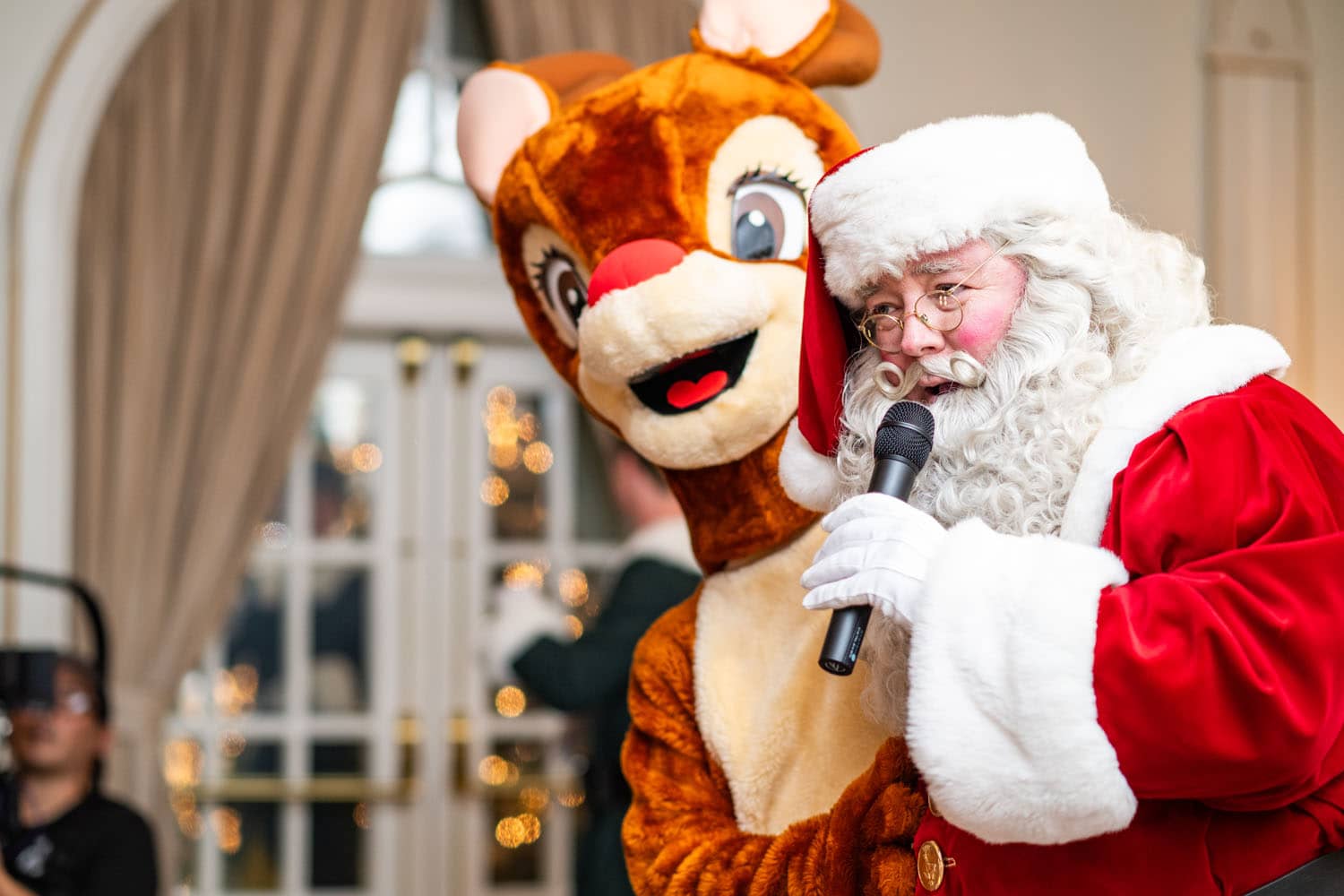 Santa performing a song on a stage