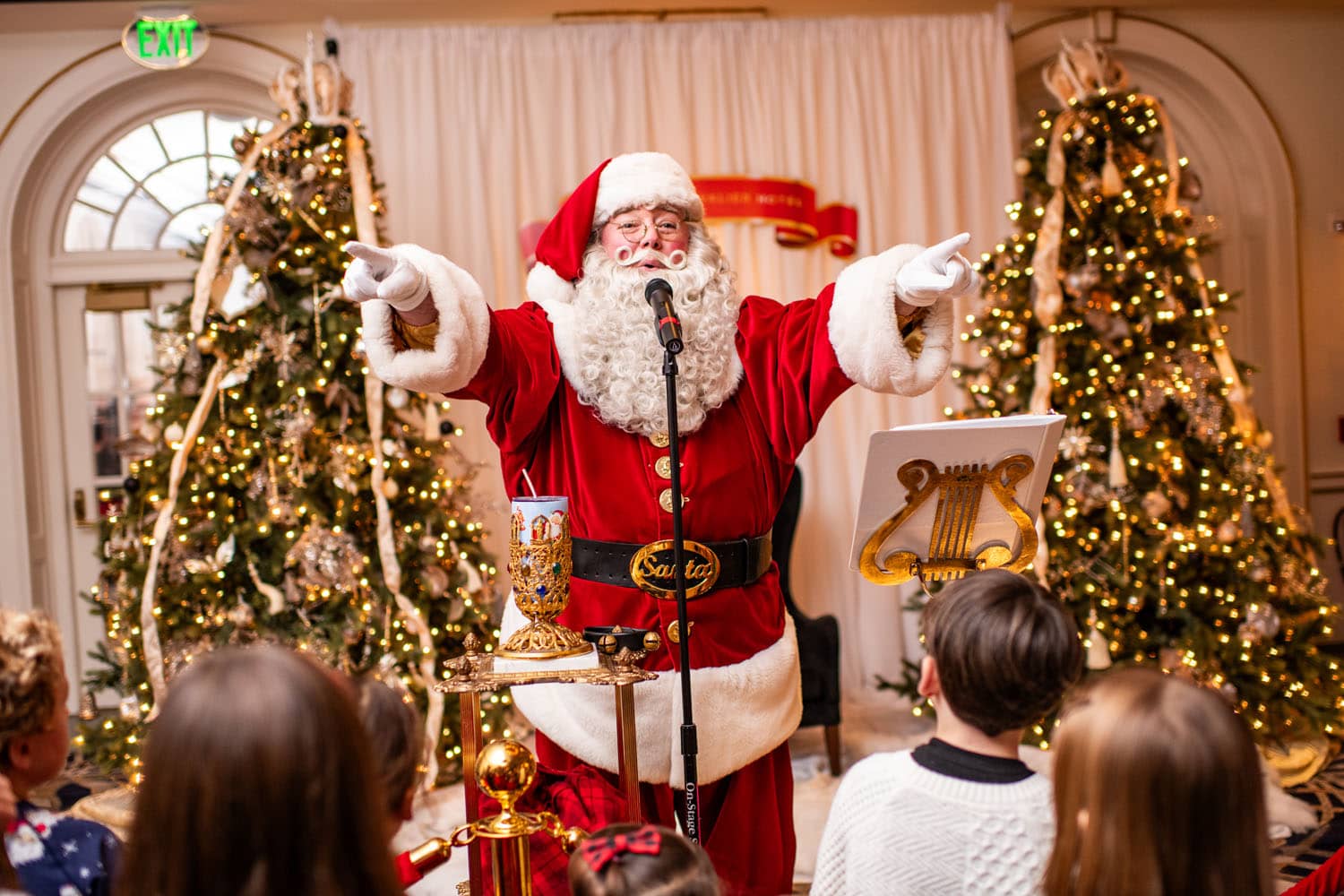 Santa performing a song on a stage