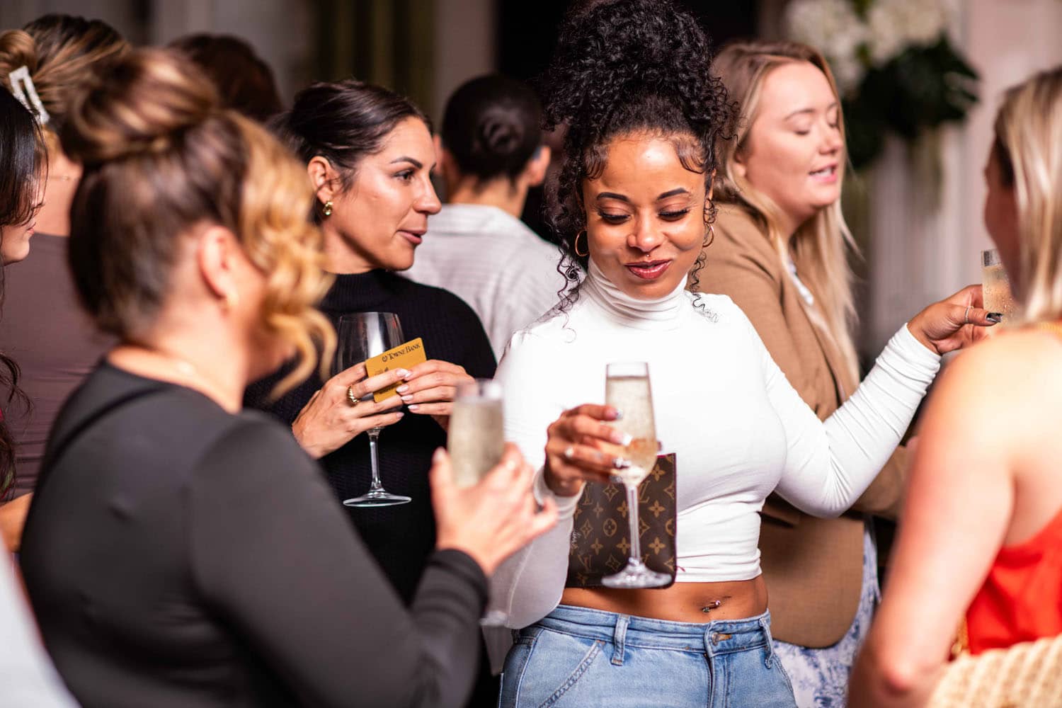 A group of women drinking champagne inside The Historic Cavalier Hotel