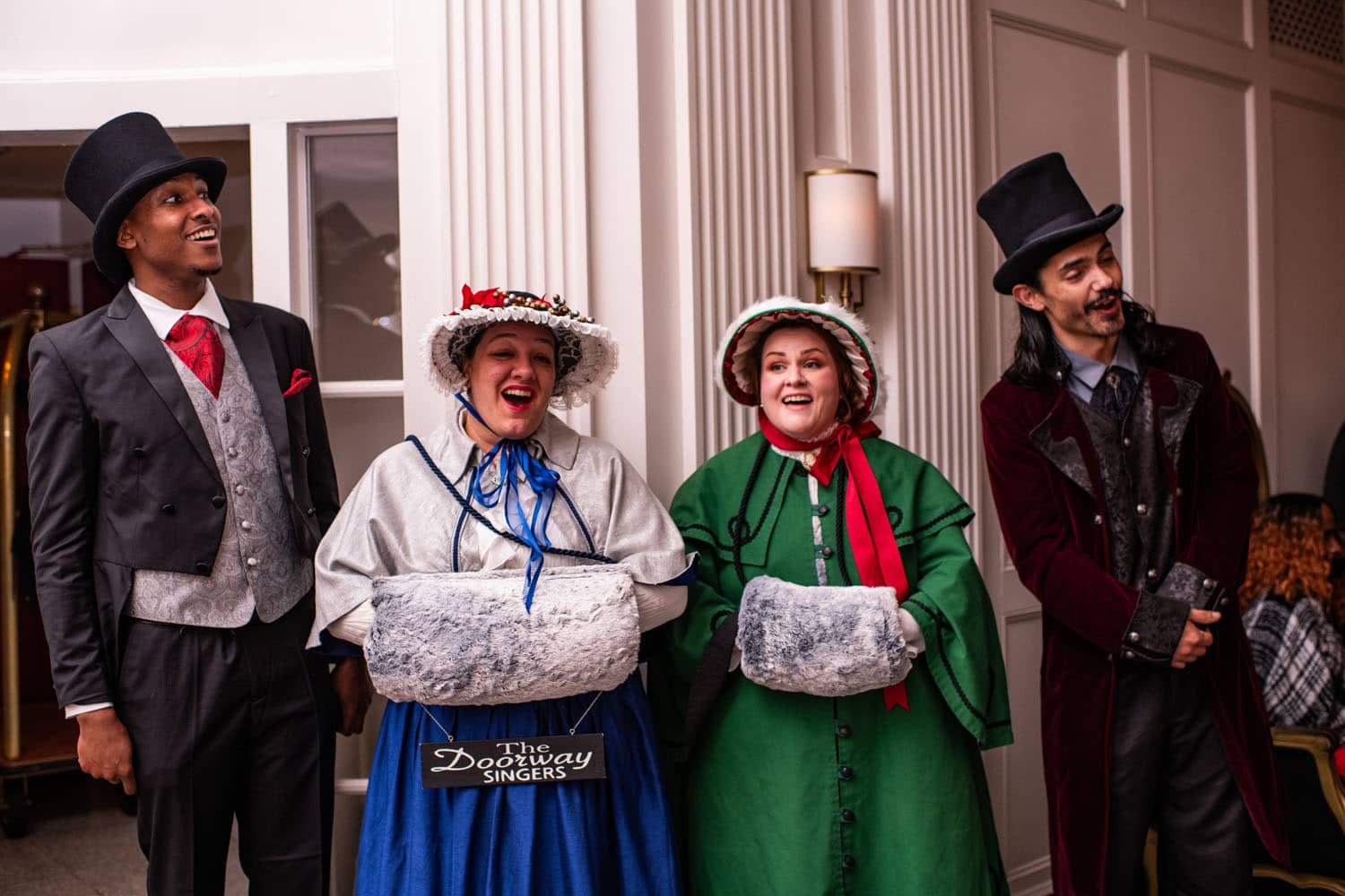 A group of carolers singing songs inside