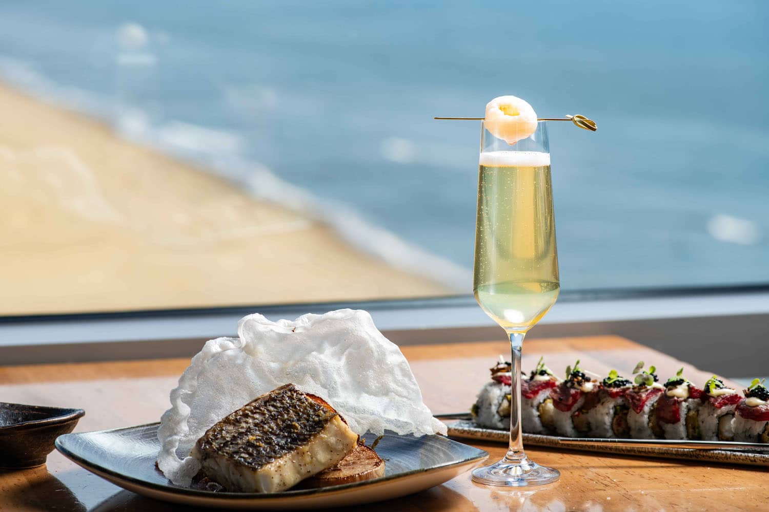 A plated meal on a table with ocean views at Orion's Roof