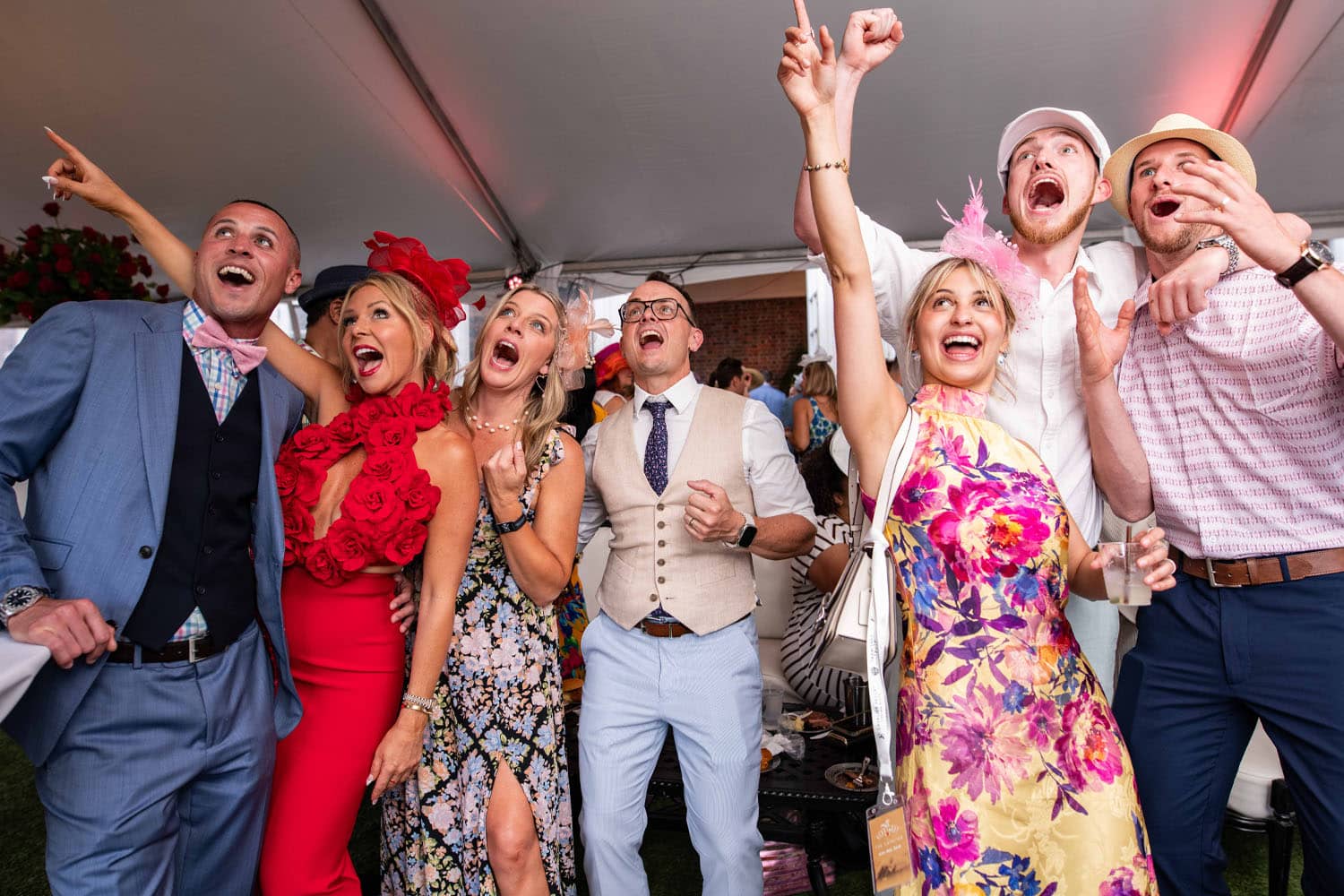 A well-dressed group of friends celebrating at a Kentucky Derby Day event at The Cavalier Hotel