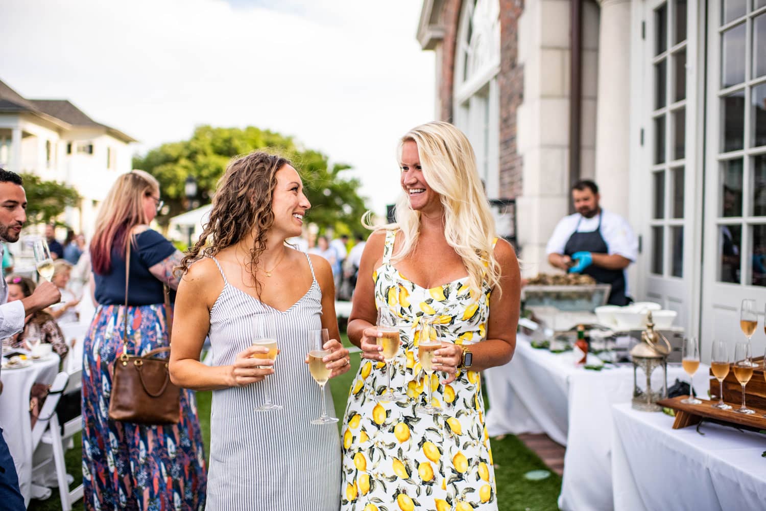 Two women enjoying an outdoor event on The Historic Cavalier Hotel Great Lawn